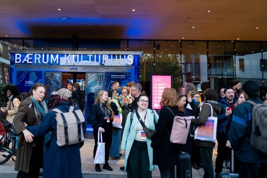 Group gathered outside a theatre chatting after a performance