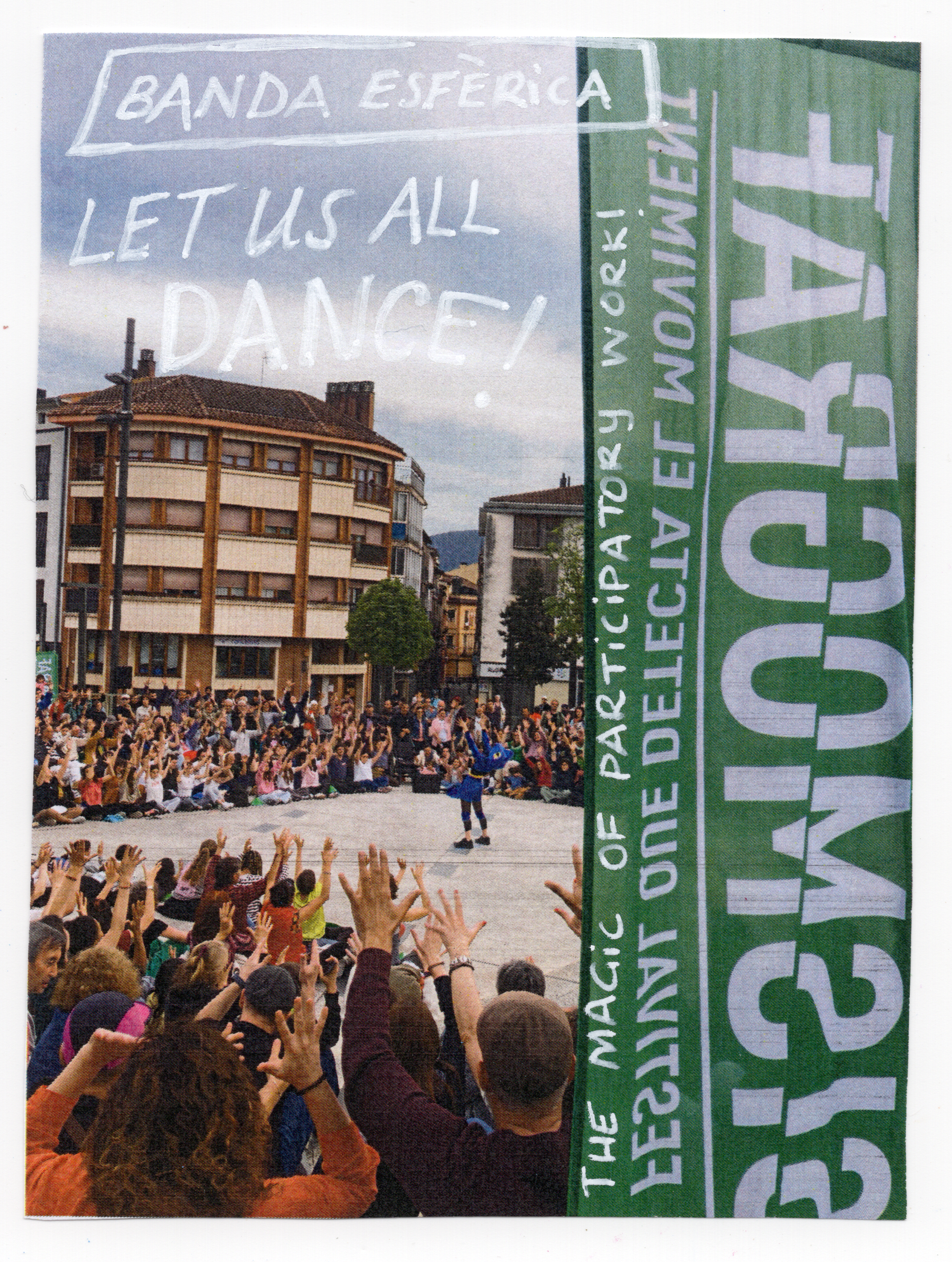 Large audience watching an outdoor performance, with handwritten text overlaid on the image