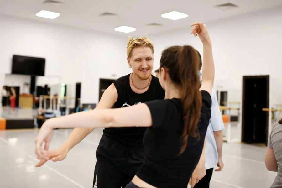 Two dance artists facing each other during a dance workshop