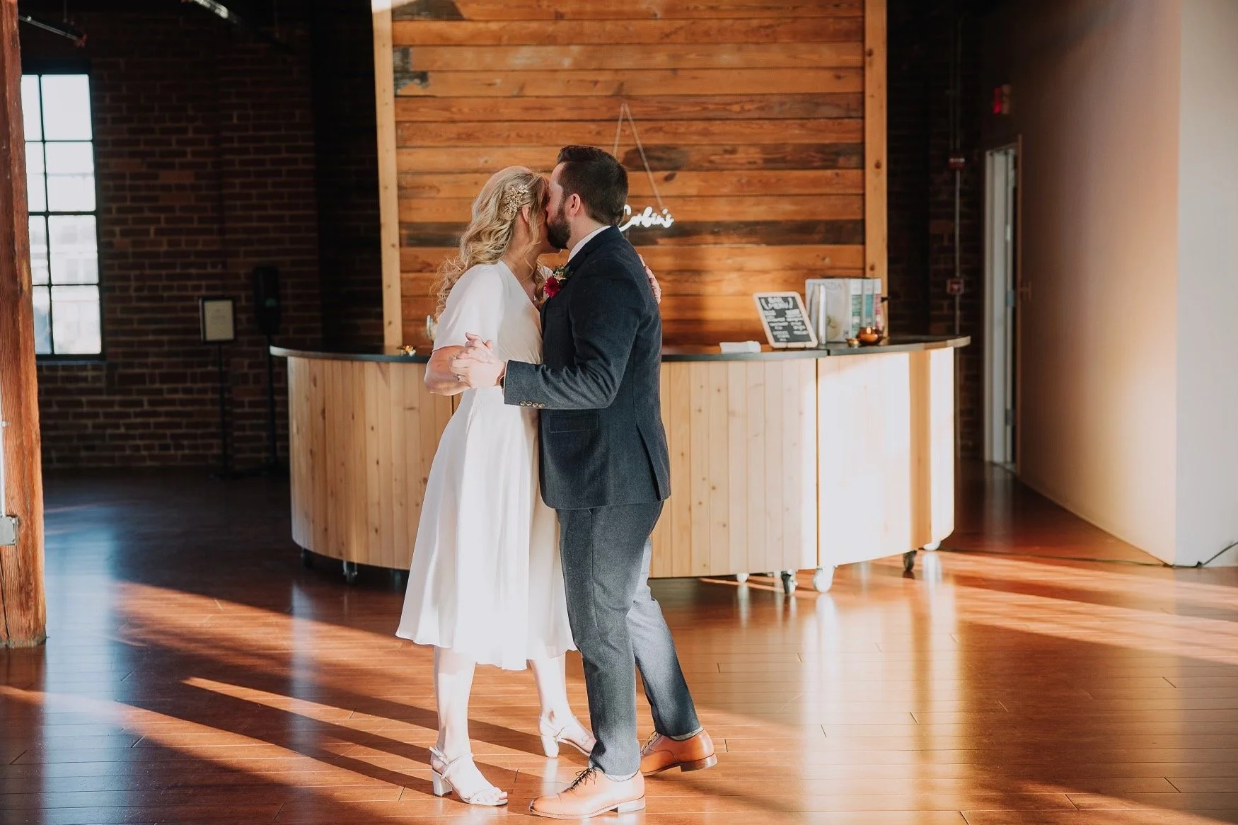 Jason and Kaley share a tender first dance moment, cheek to cheek, on their wedding day, reflecting the connection built at Emilie Cole Studios.