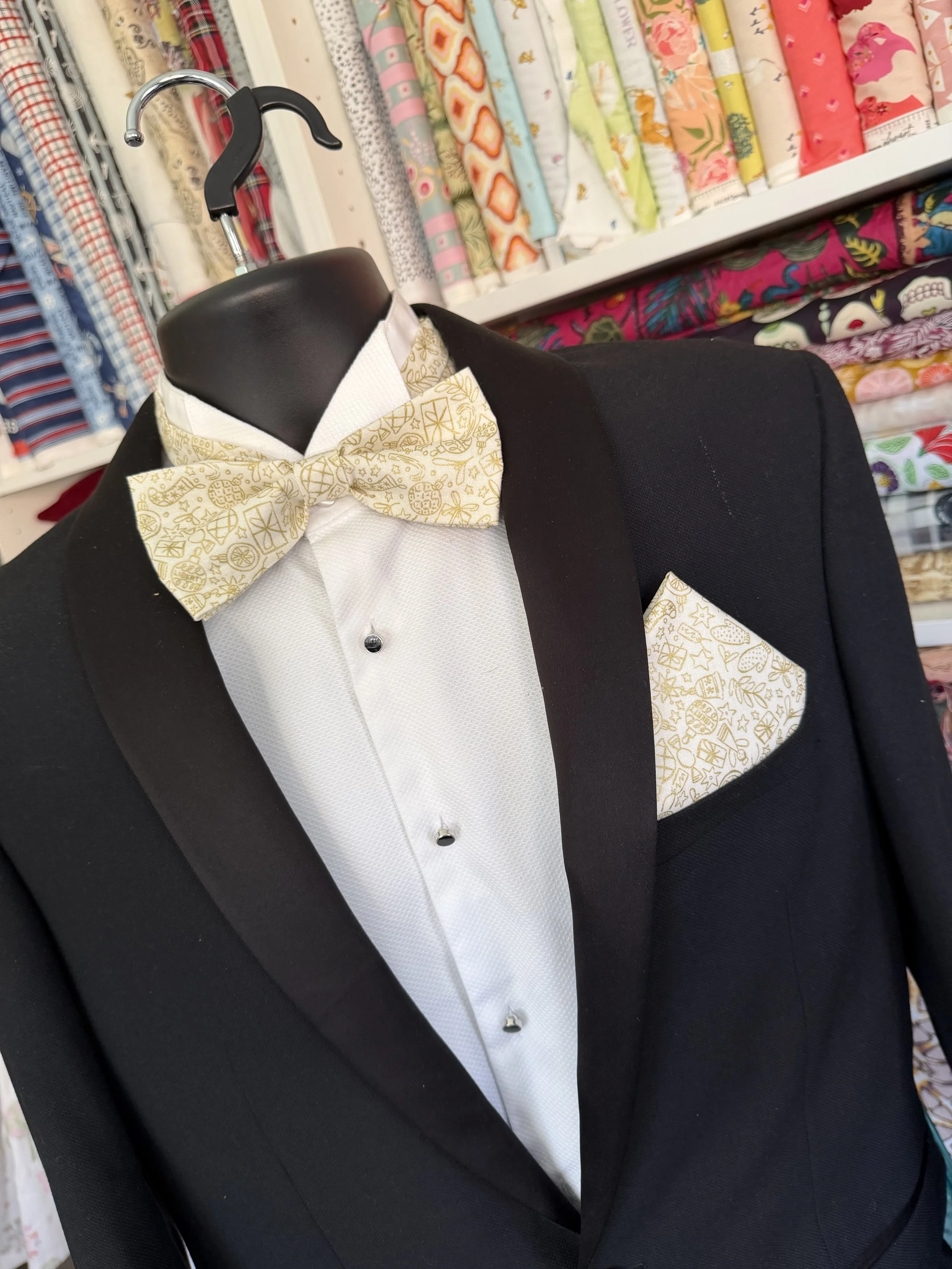 Handmade sewjackie bow tie and matching pocket square in liberty fabric, featuring gold festive icons on cream fabric