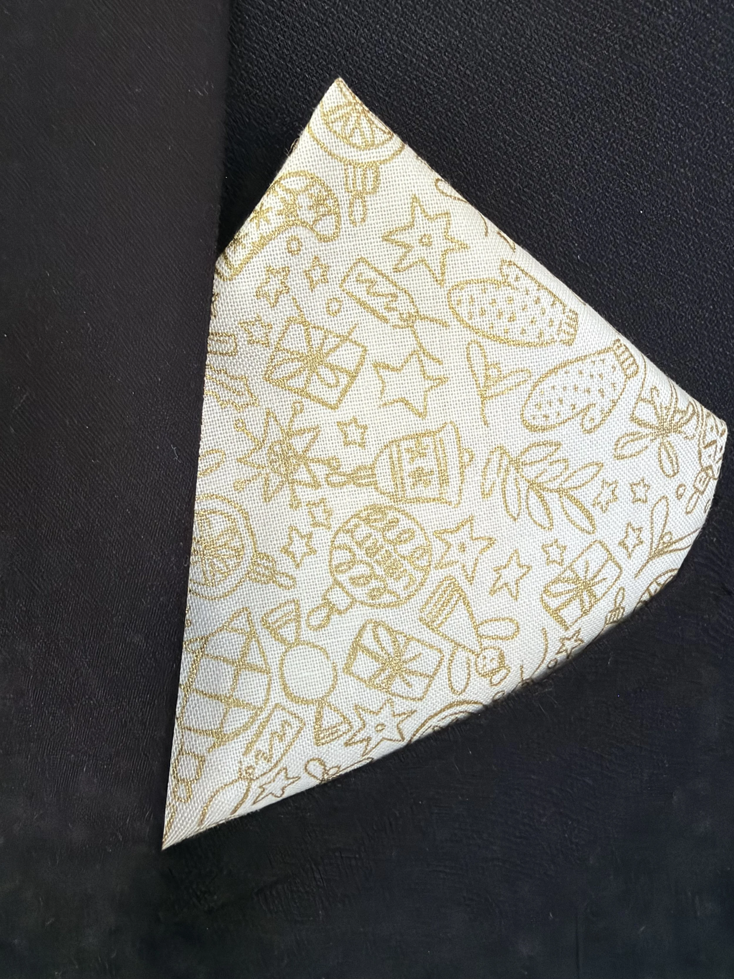Handmade sewjackie  pocket square in liberty fabric, featuring gold festive icons on cream fabric