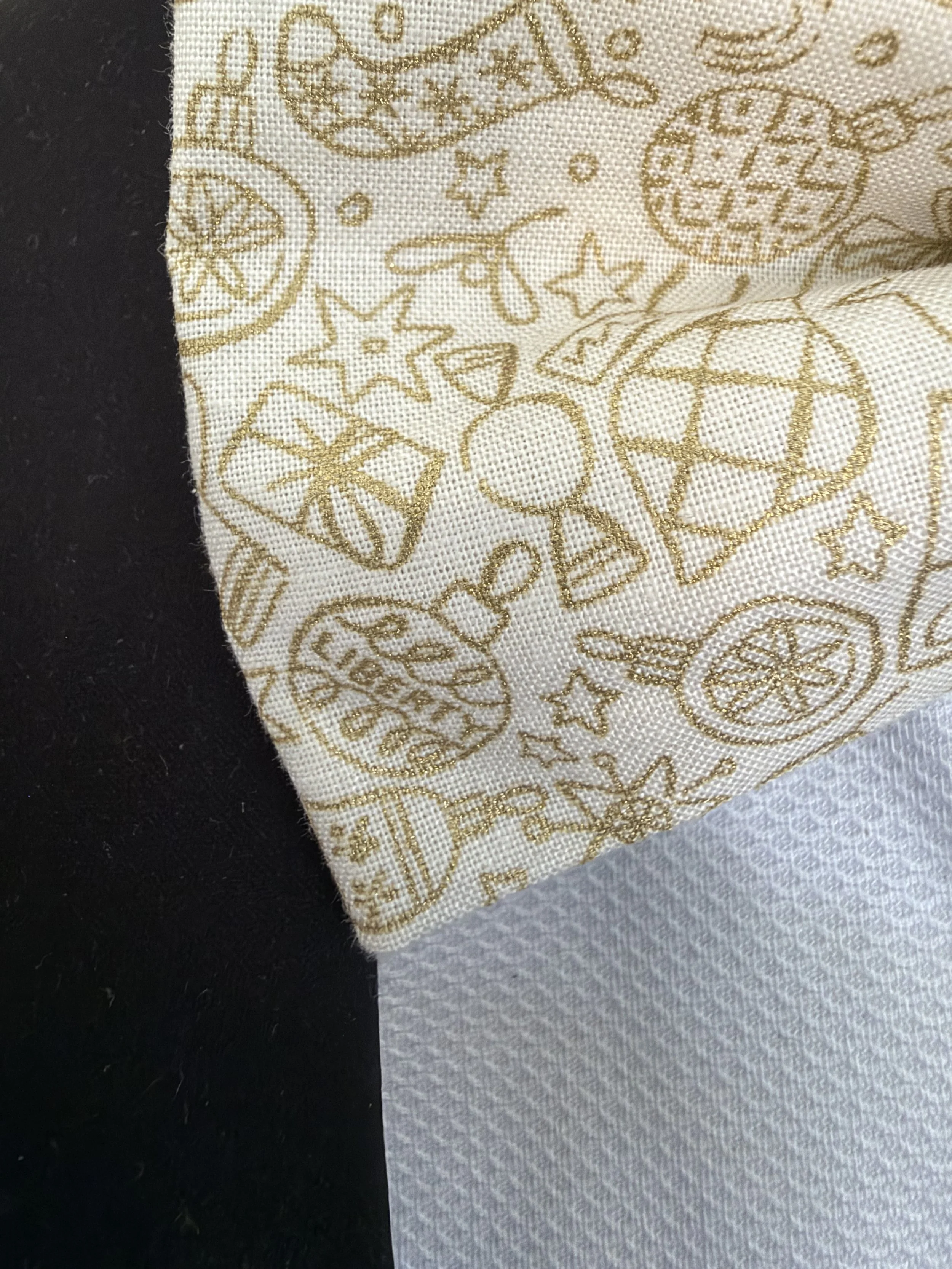Handmade sewjackie  pocket square in liberty fabric, featuring gold festive icons on cream fabric