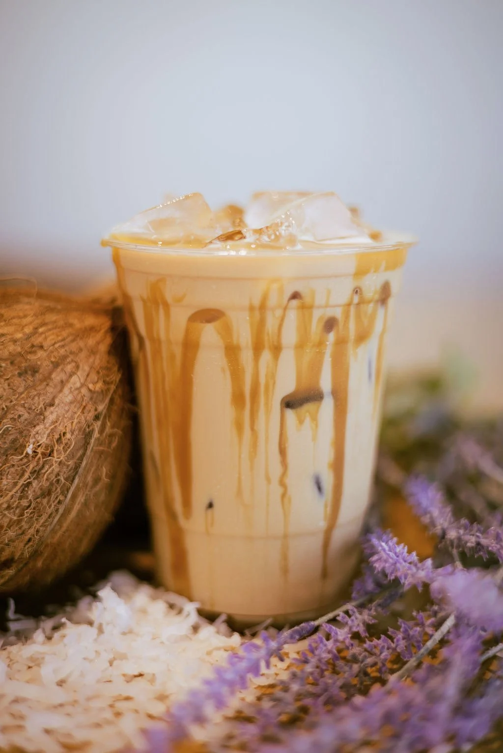 Iced caramel latte with flowers and a coconut as decor