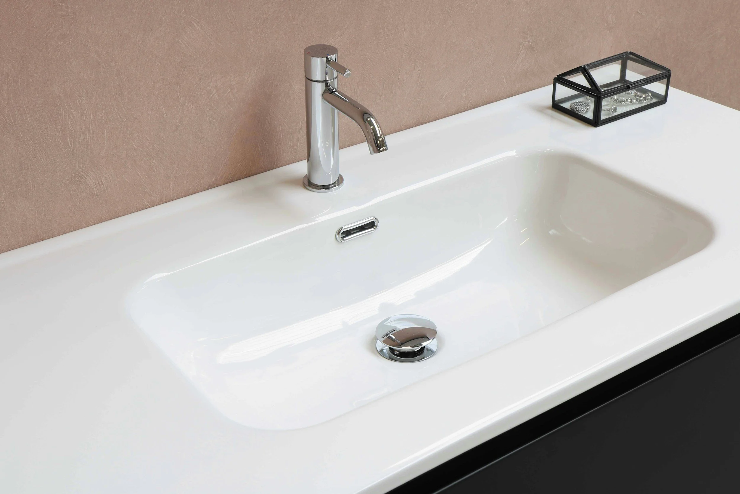 Clean bathroom sink with wiped down counter and no items on counter