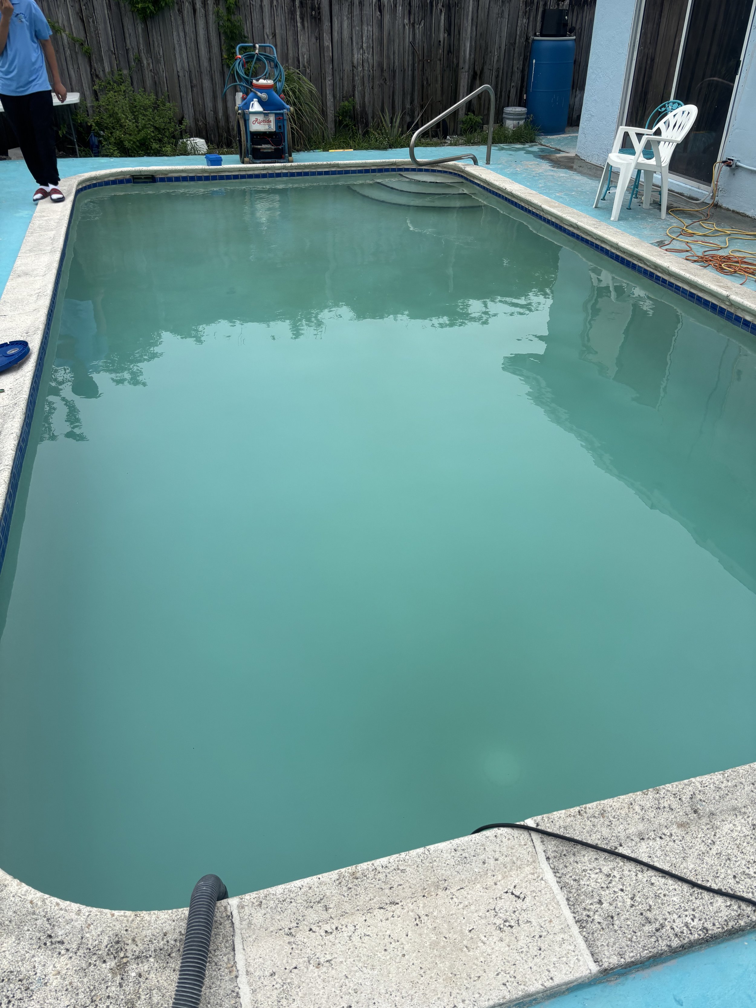Green murky algae pool before pool shock and pool maintenance