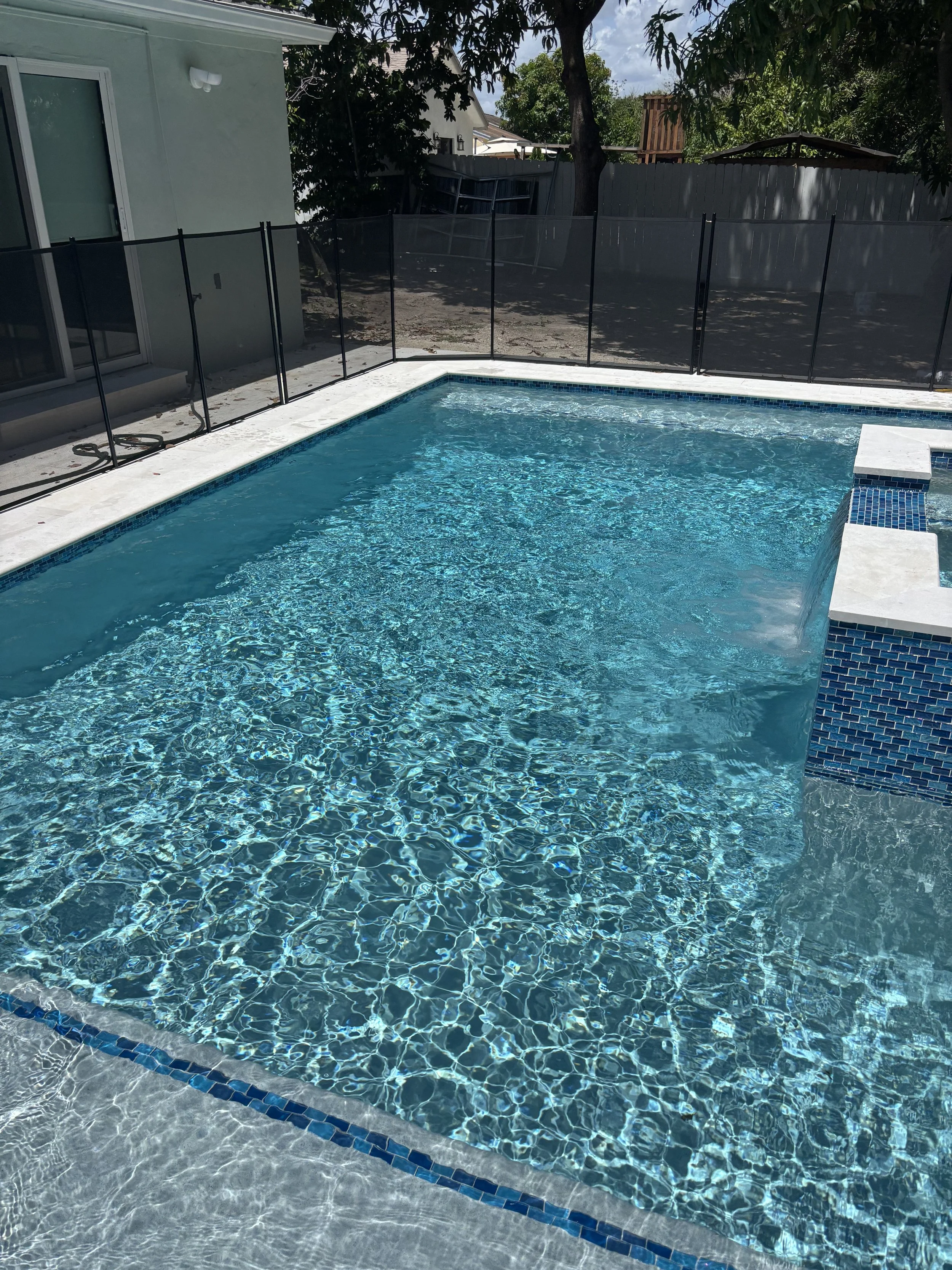 Sky blue pool with spa with clear clean water after pool maintenance