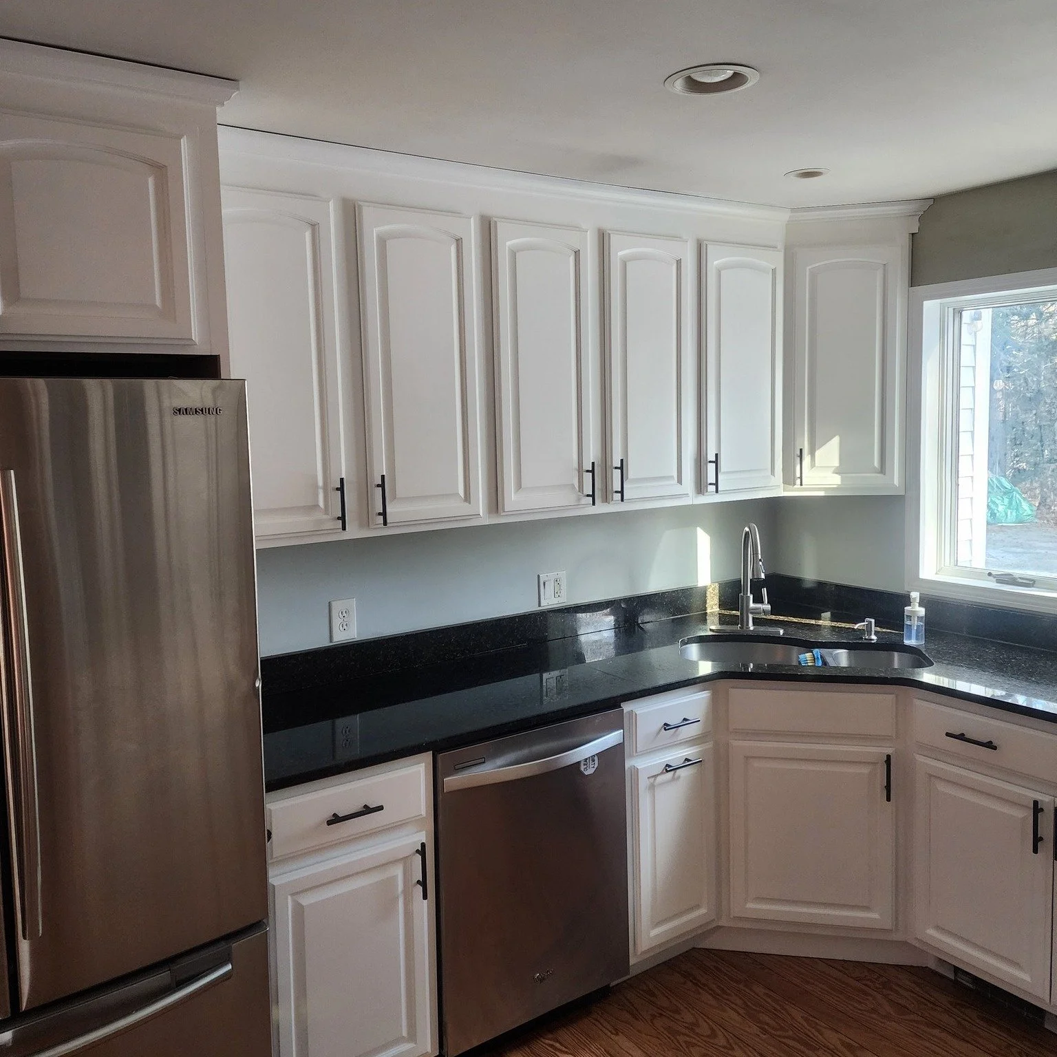Most people only see the finished kitchen.
Here&rsquo;s a little of what happens before the cabinets go back up.

Doors are removed, sprayed in a controlled setup, and given proper time to dry before reinstalling. Taking the time to do it carefully i