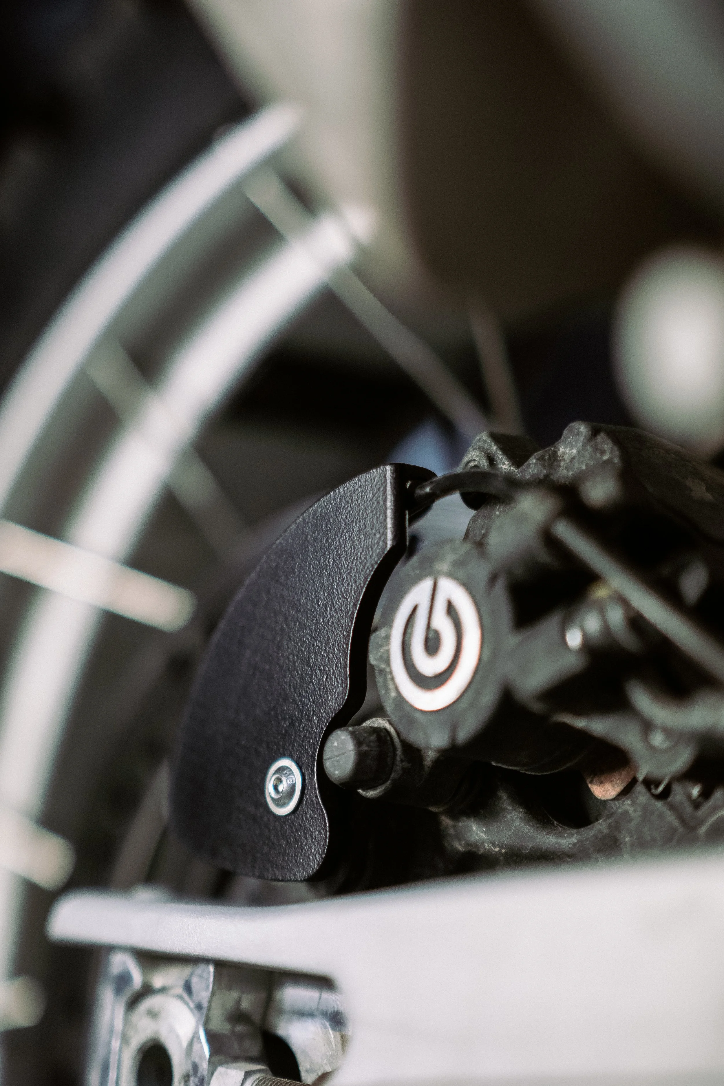 Close-up of Aprilia Tuareg 660 rear disc brake, including the brake disc, caliper, and surrounding components.