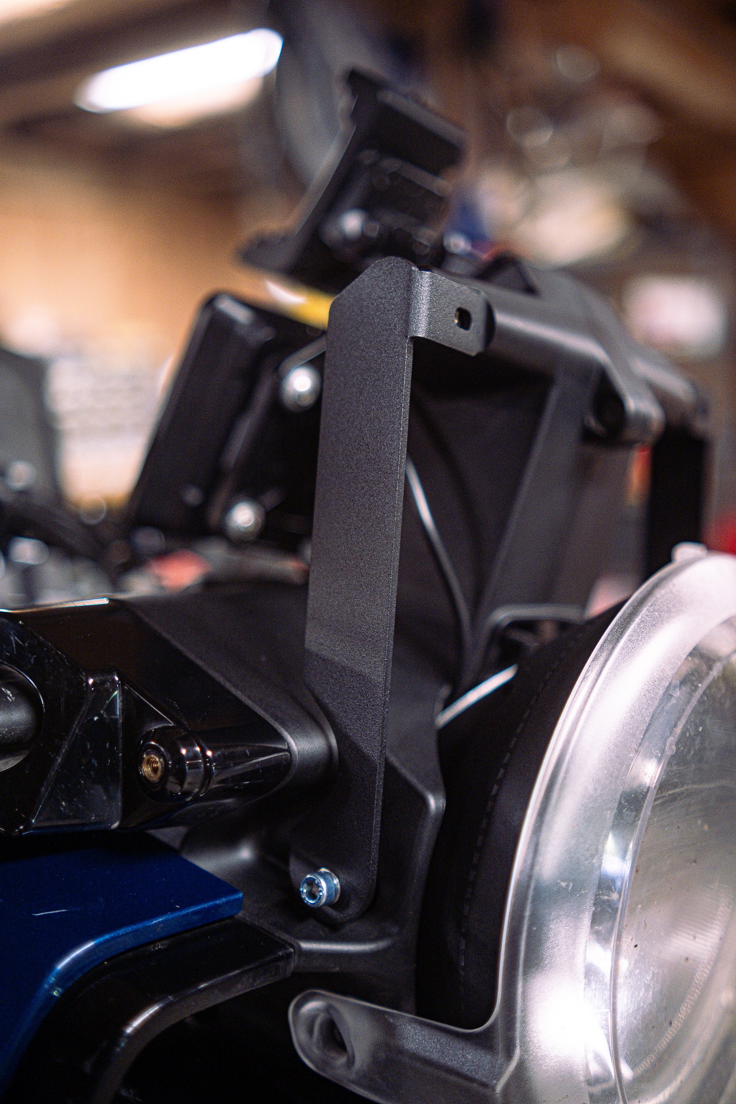 Close-up of a camera mounted on a stabilizer or gimbal, with a blurred outdoor background.