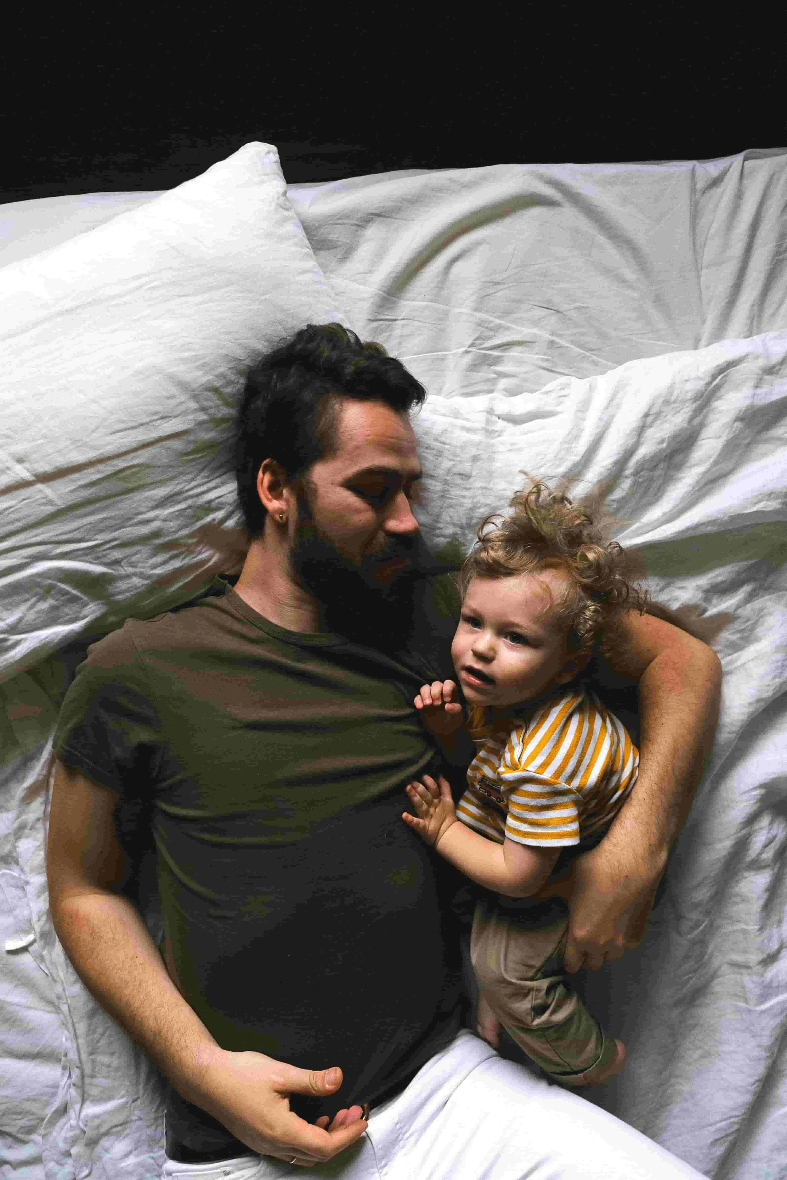 dad and baby in bed