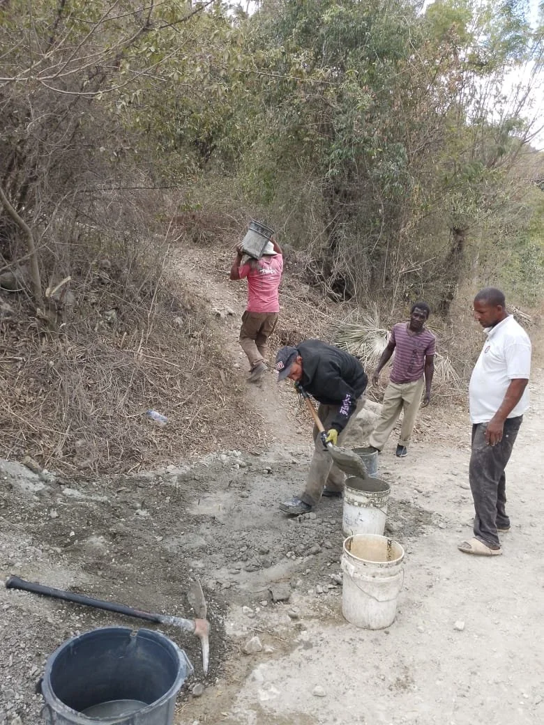 The beginning stages of constructing a water tank for the community.