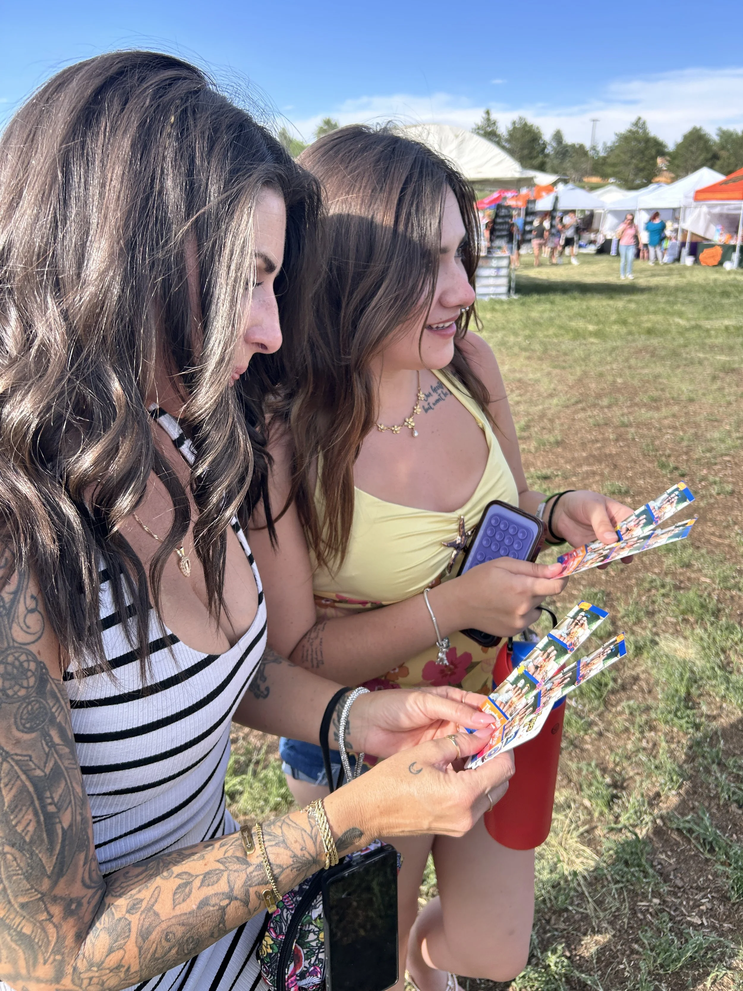 Photo booth attendees looking at their photo strips