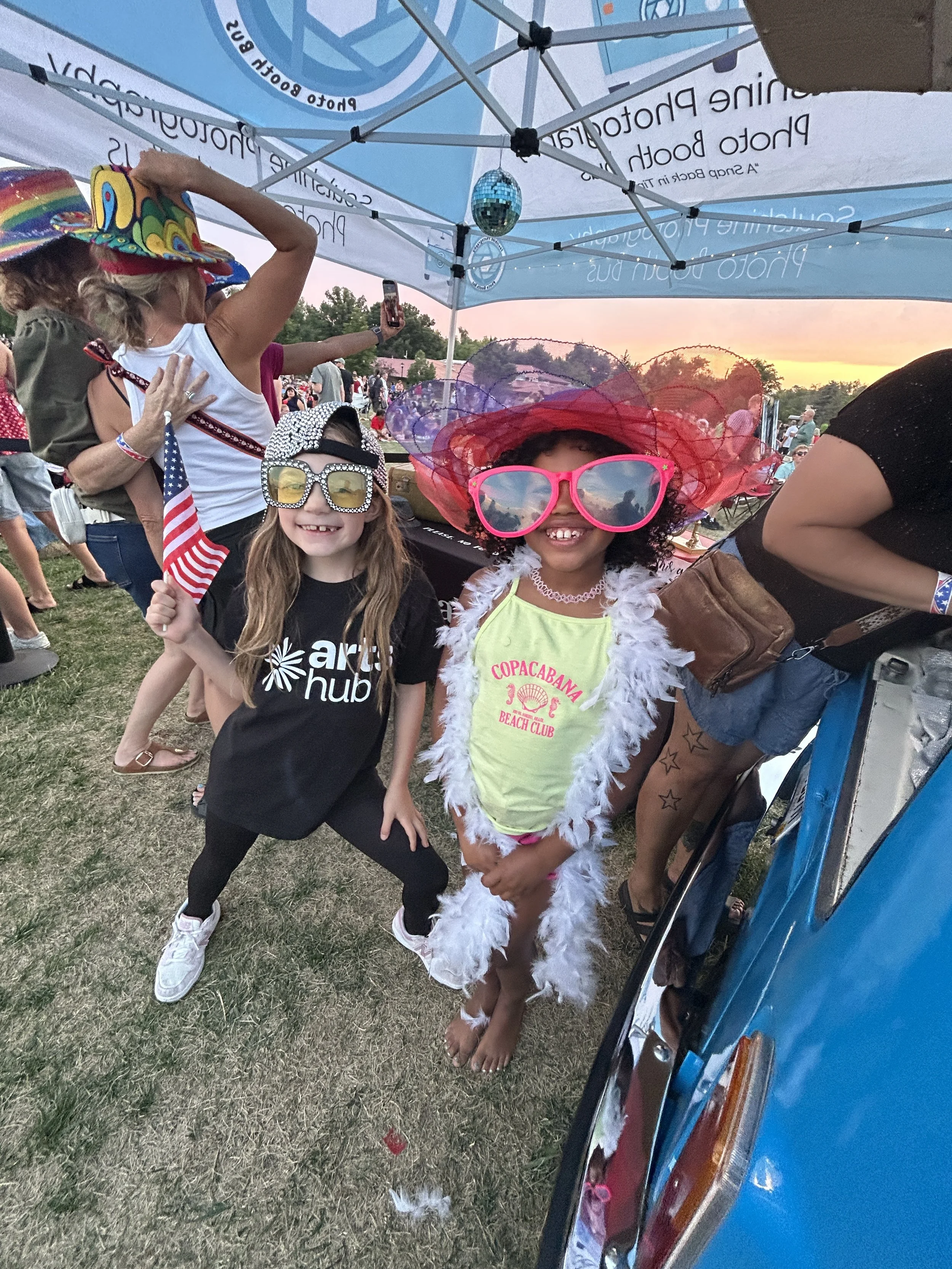 Kids at the photo booth trying on props