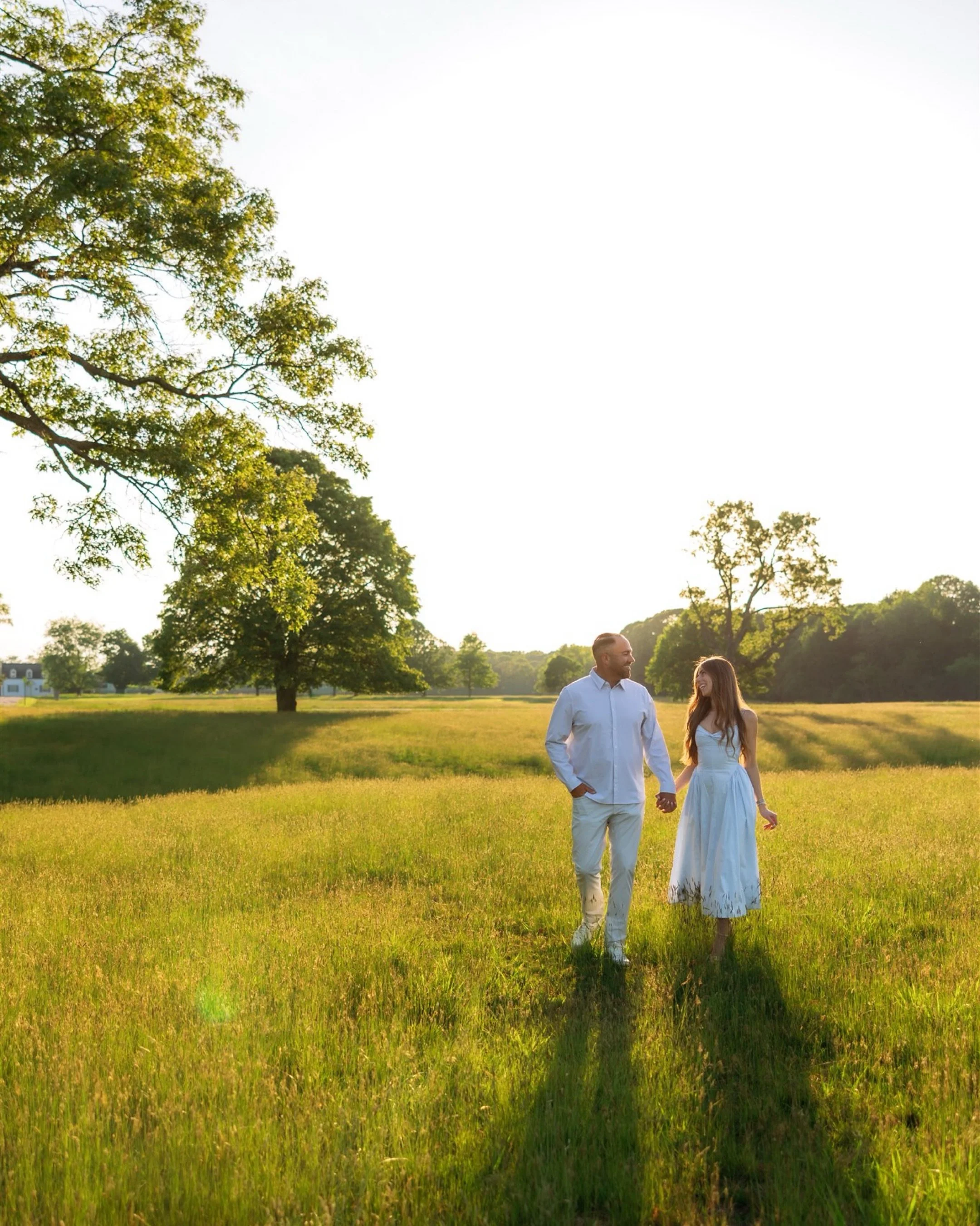 Nick and Kristin. Bathed in golden light, a pre-dinner walk in the park turned into a surprise proposal in a place filled with meaning.