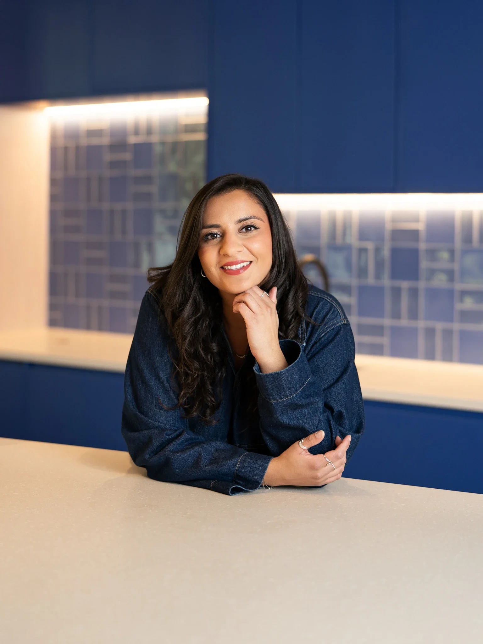 Female finance professional, office environmental backdrop, denim outfit, smile, st pancras