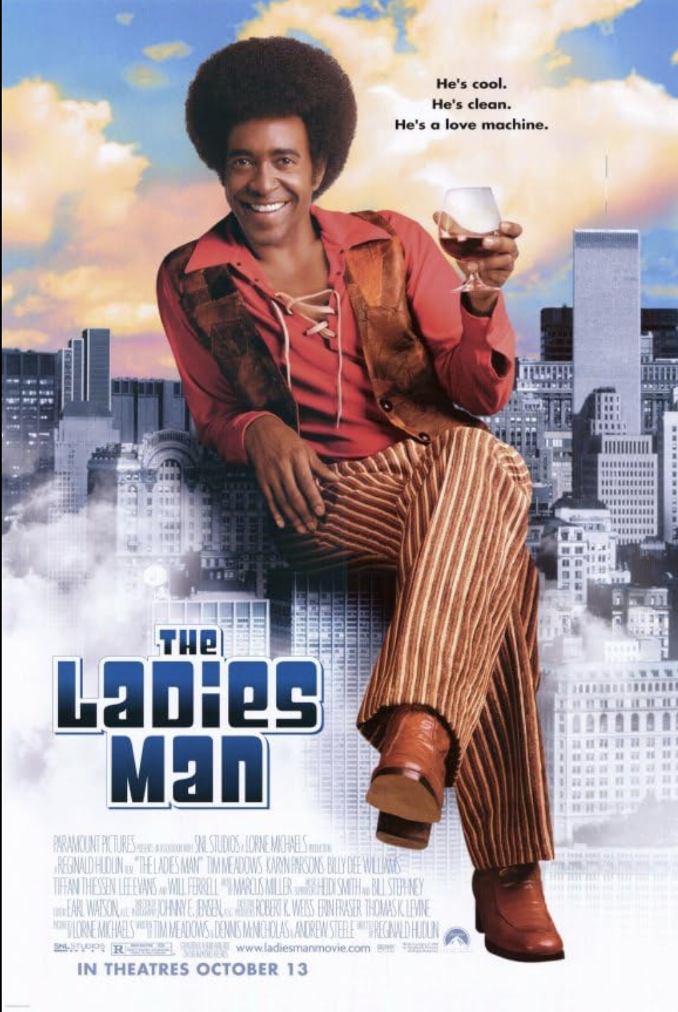 Promotional poster for the movie 'The Ladies Man' featuring a man with an afro hairstyle smiling, holding a glass of red wine, sitting against a city skyline with clouds in the sky.