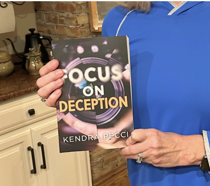 Open book with pages folded into a heart shape, surrounded by warm fairy lights.