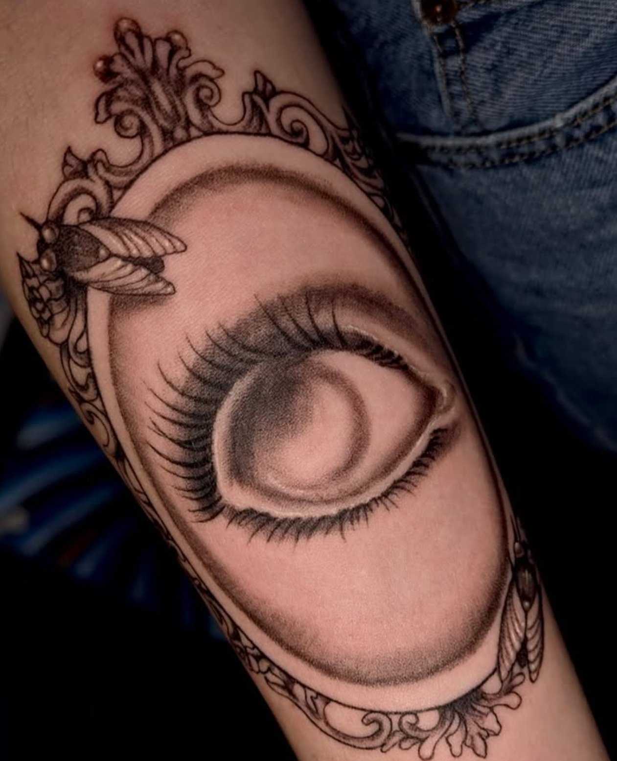eye in victorian frame mirror on skin
