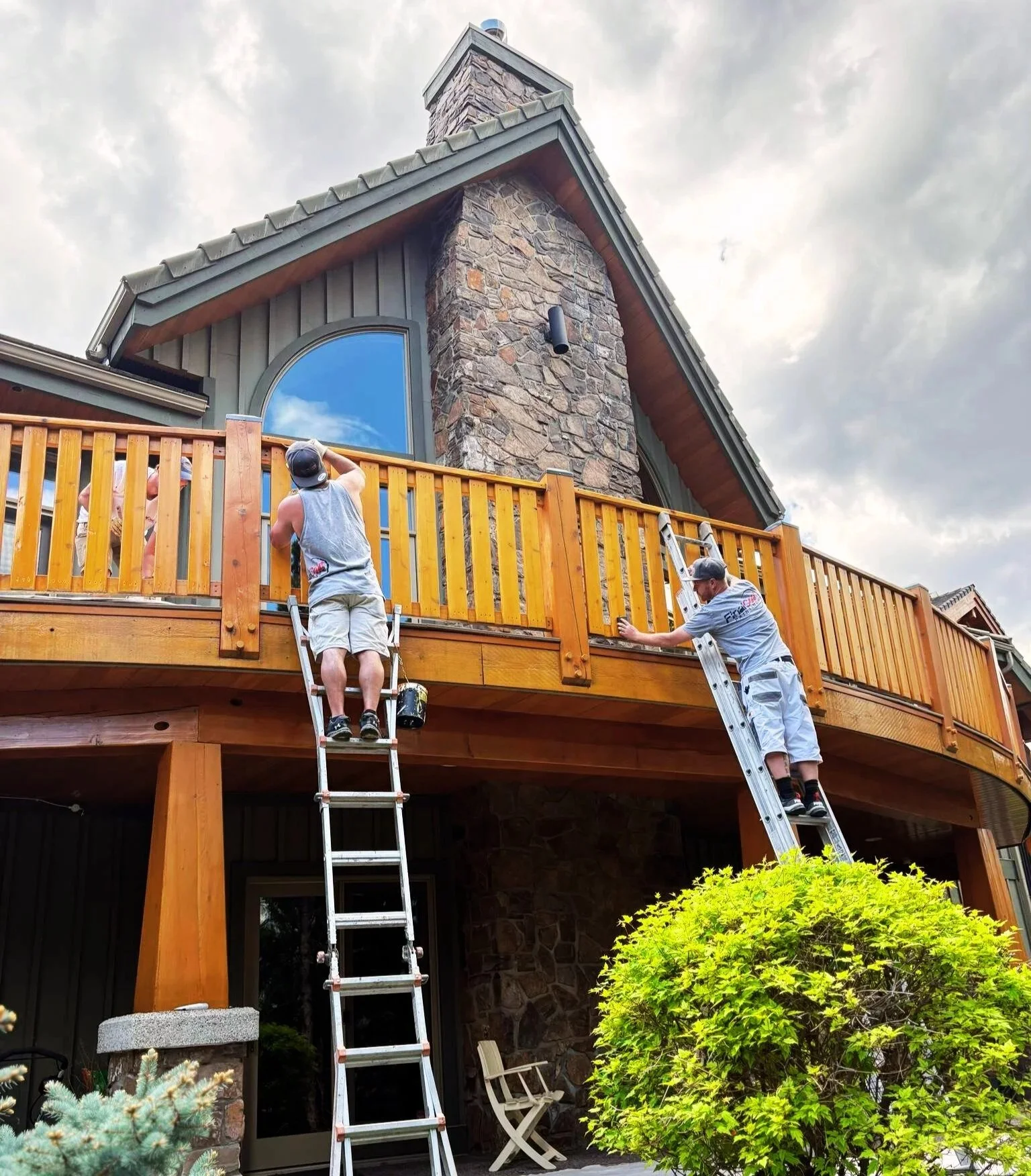 exterior painting contractor working on canmore home