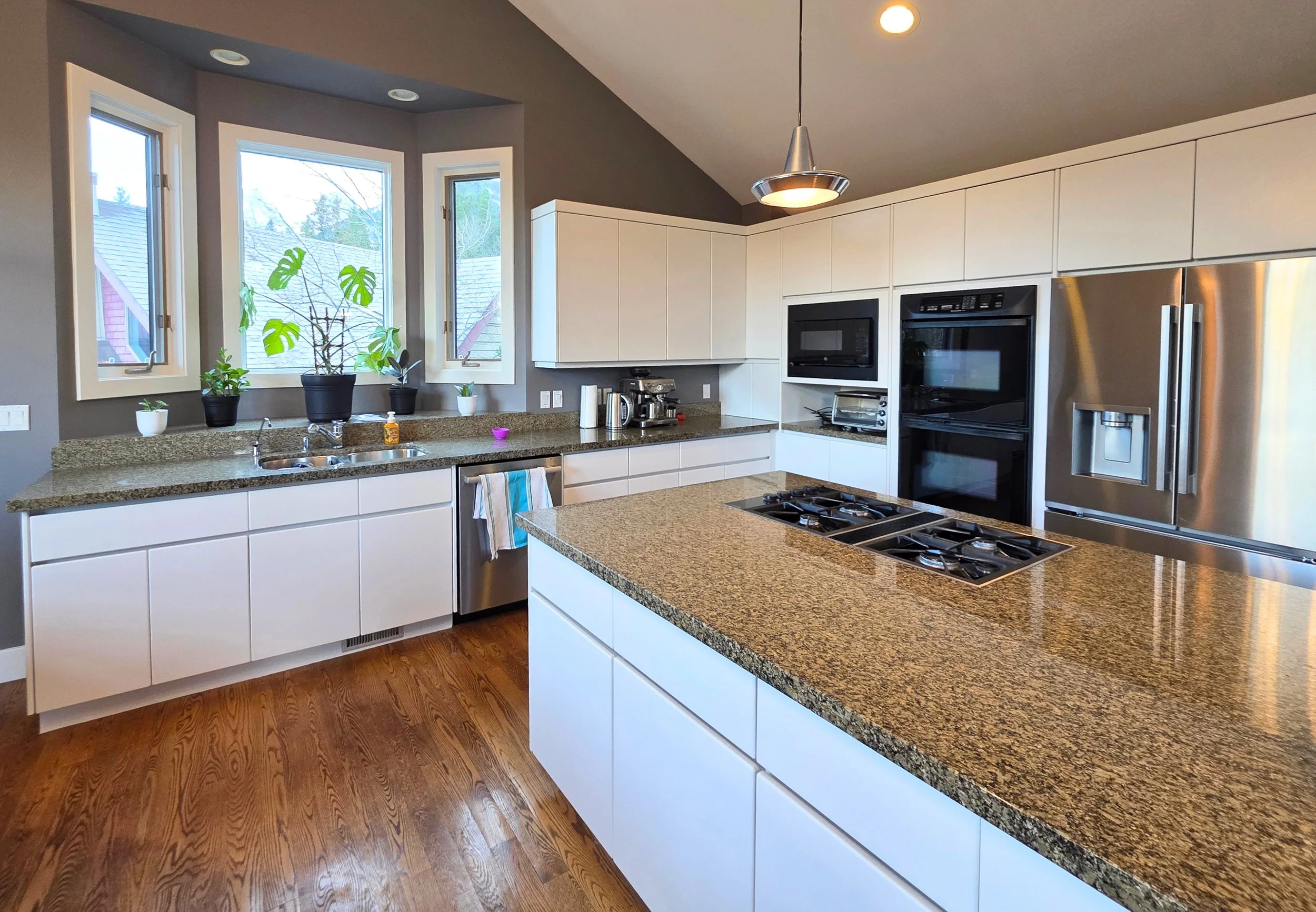 Kitchen cabinet refinishing before and after in Canmore, Alberta — Final Coat Painting Inc.