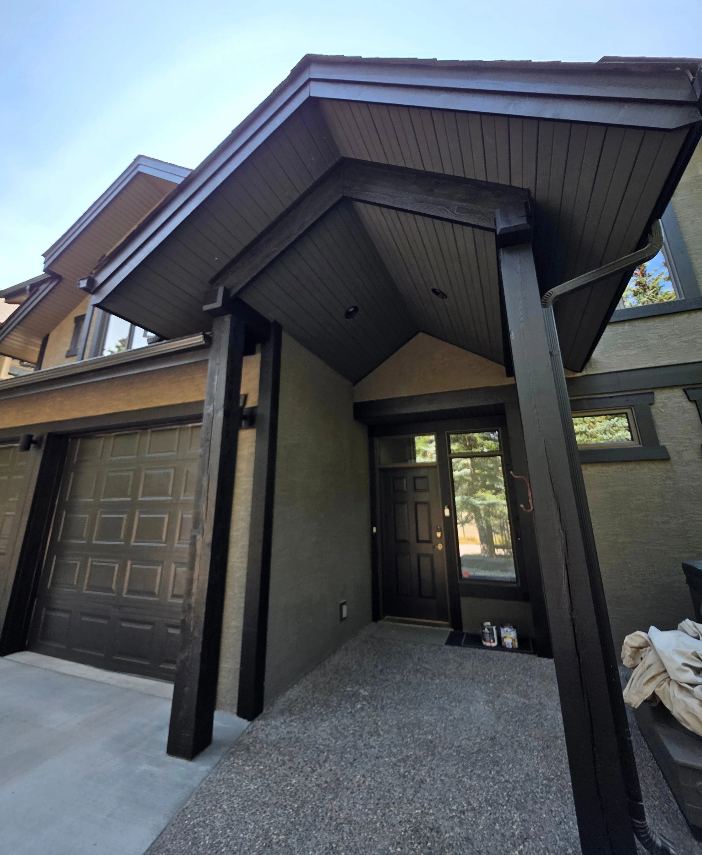 Exterior painting on 1st Street, Canmore: black trim and Black Beauty entry and garage doors — Final Coat Painting