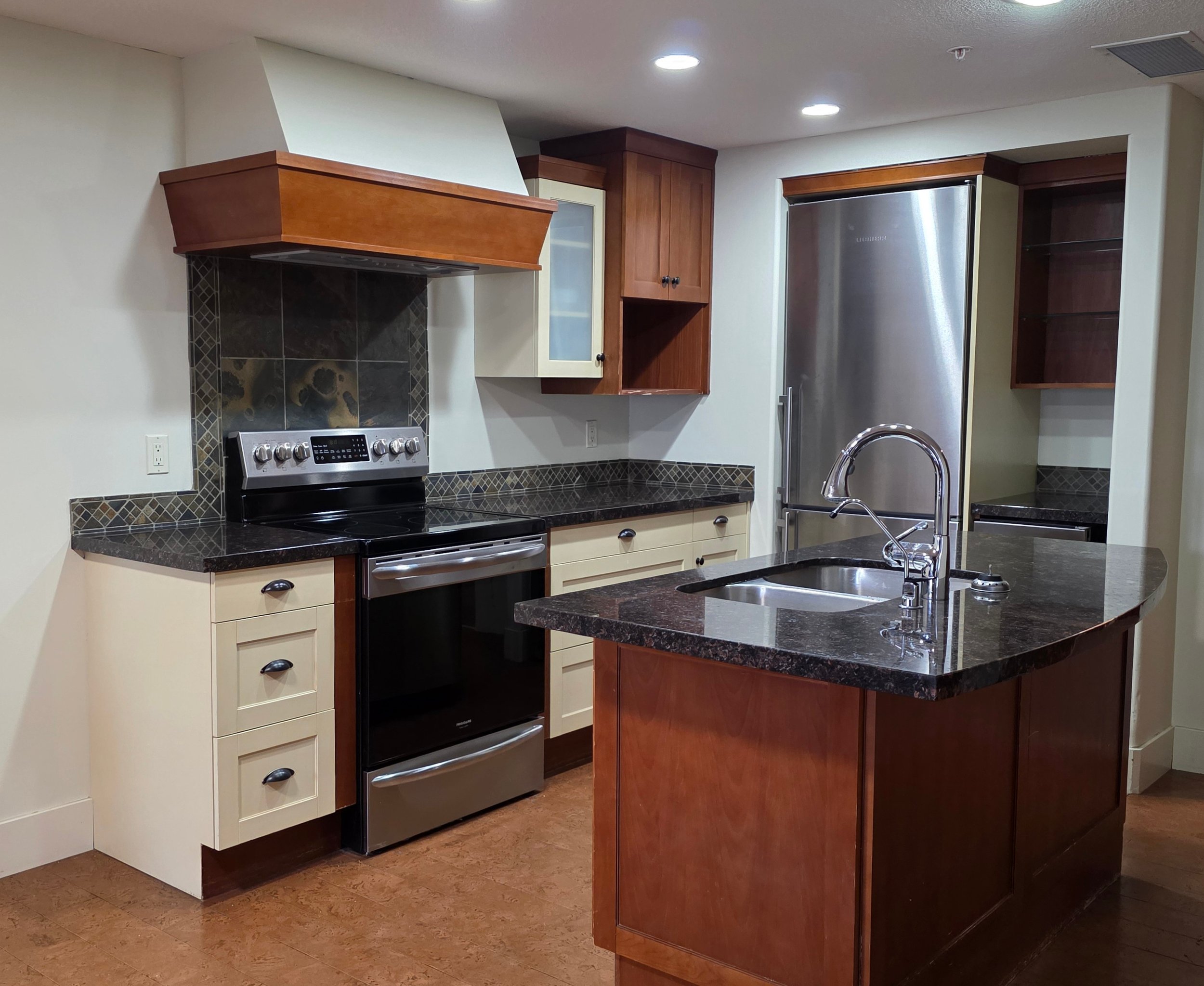 Before - Full kitchen cabinet refinishing project at Solara Bow, Canmore, by Final Coat Painting Inc.