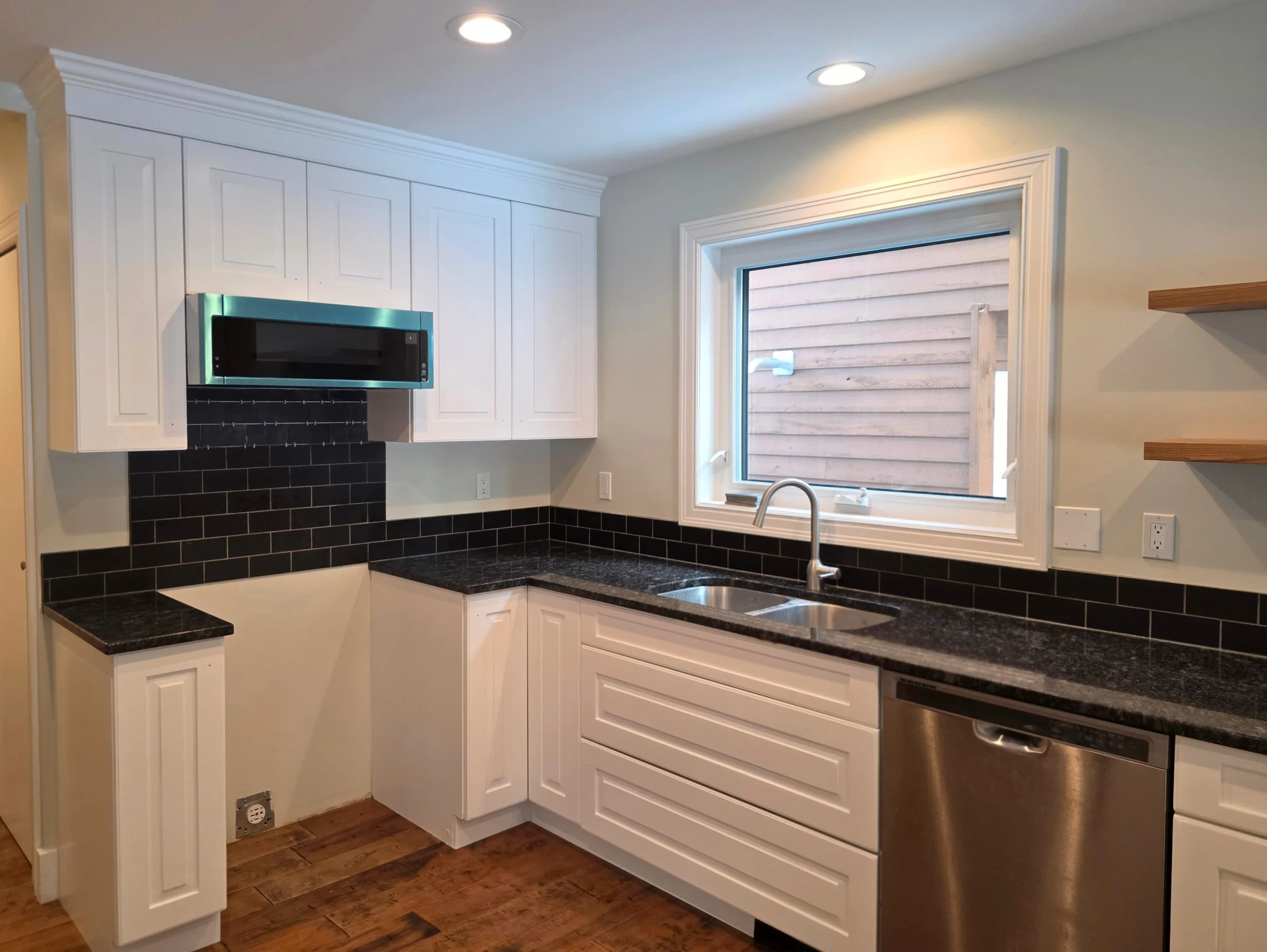 Refinished kitchen cabinets in Canmore, Alberta — factory-quality sprayed finish by Final Coat Painting Inc.