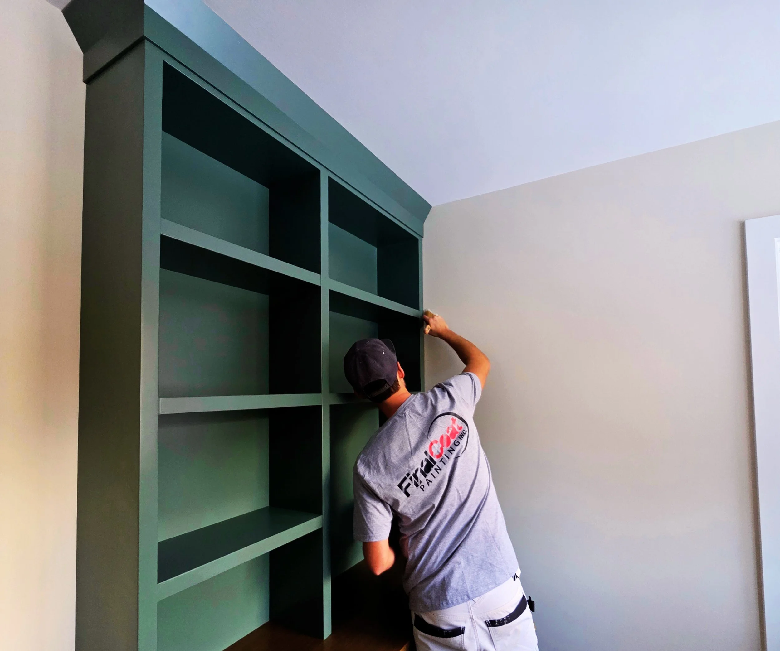 Canmore Painter cutting a wall