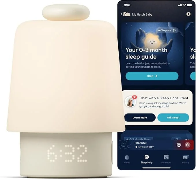 A white baby sleep device with a digital clock showing 6:32 next to a smartphone displaying a sleep guide app for newborns.