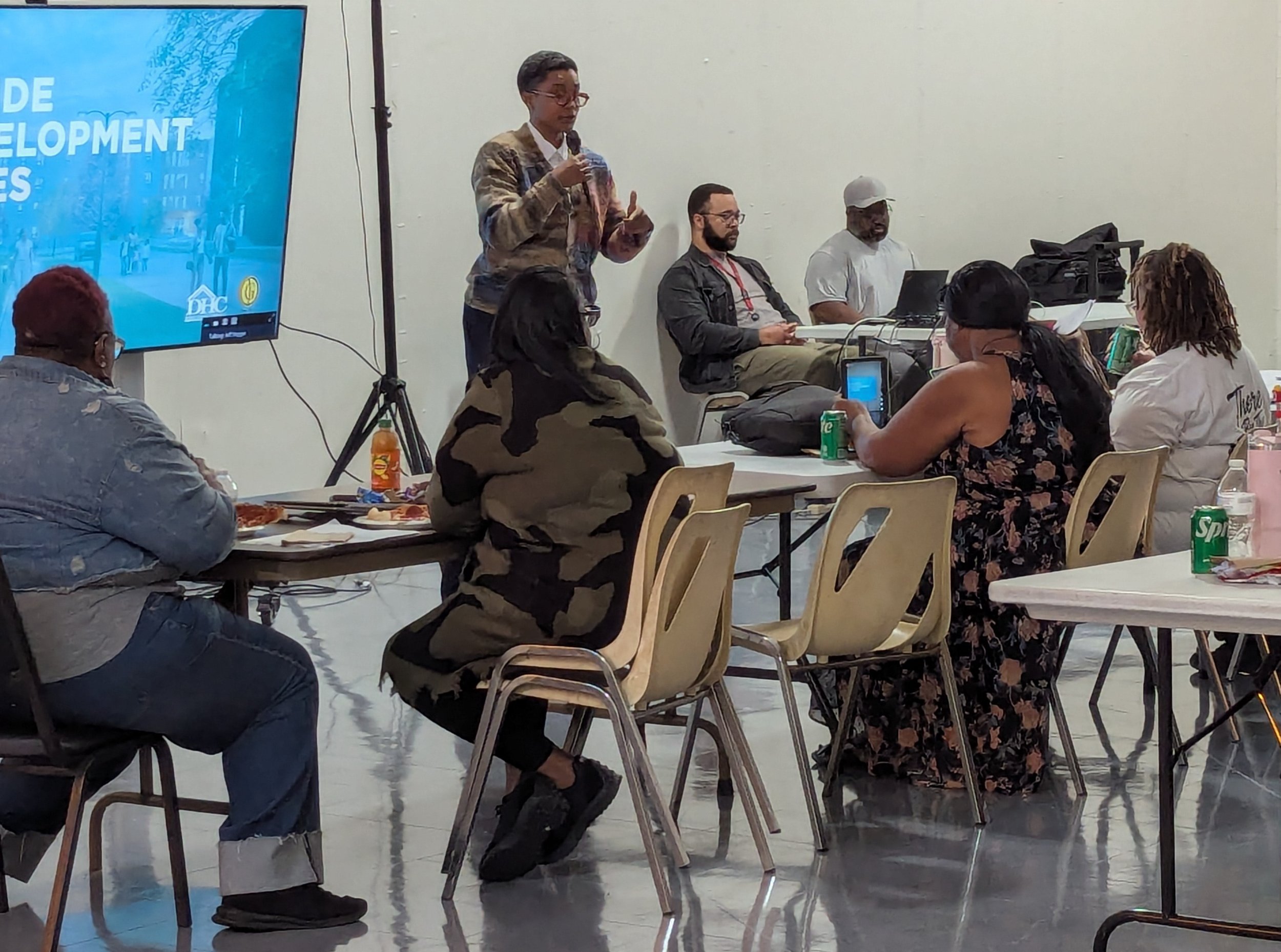 A presenter speaks with residents during the October 28, 2026 Parkside redevelopment meeting.