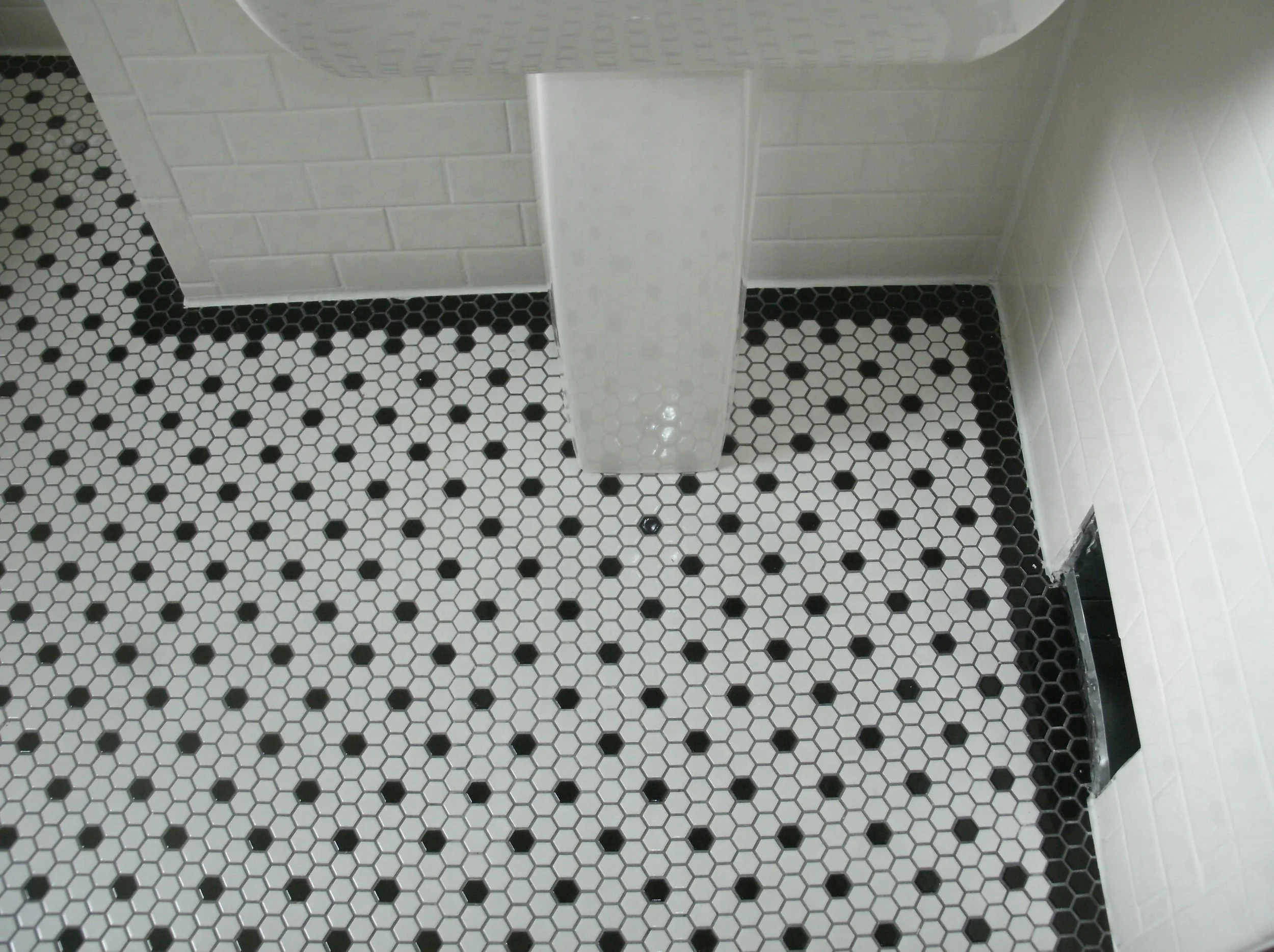 View of the wall with the sink with toilet alcove to the left