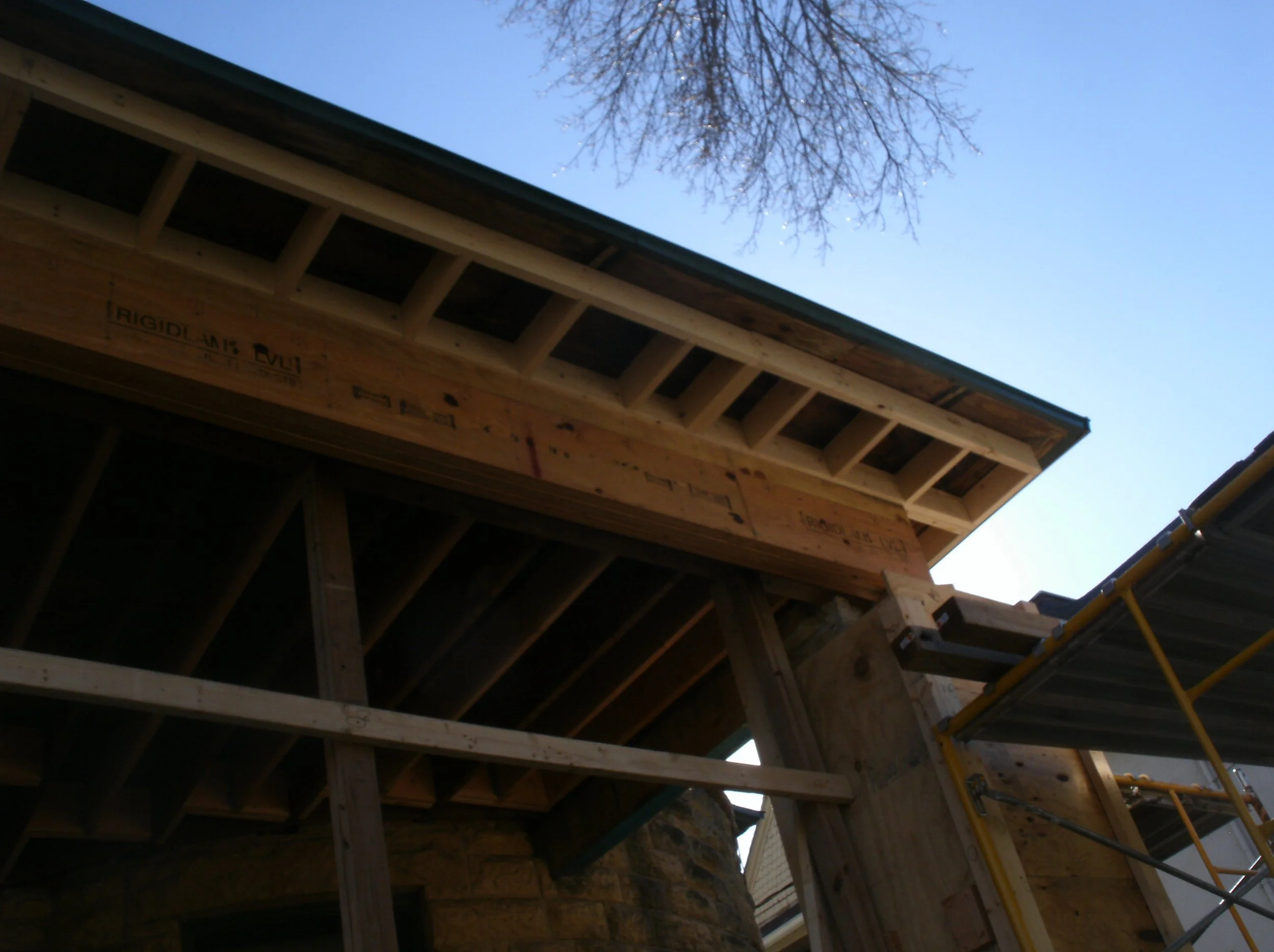 Giant three part LVL beam in place. New rafter extensions outside of beam.