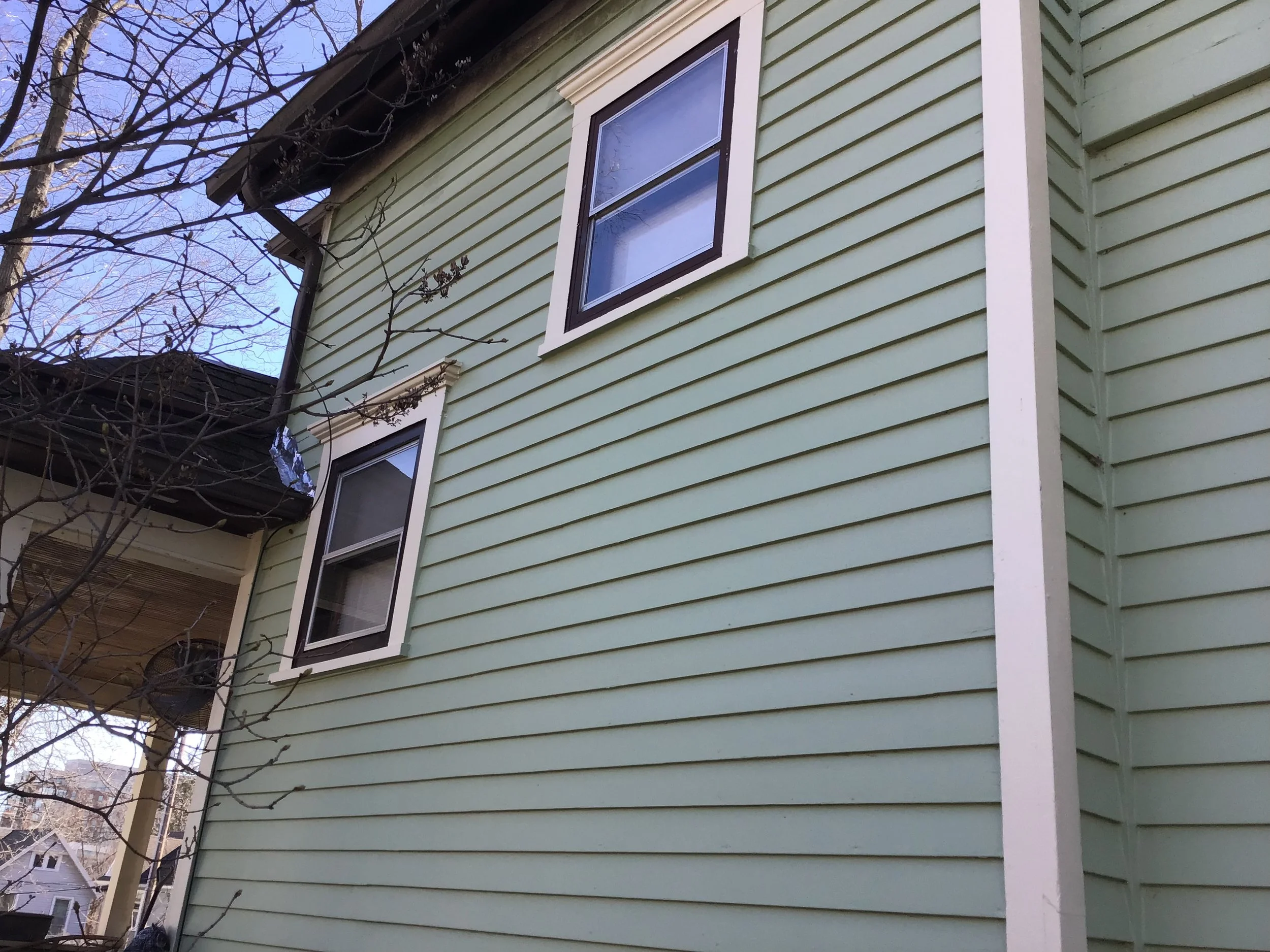 The two windows finished and painted. Note flashing on adjacent roof.