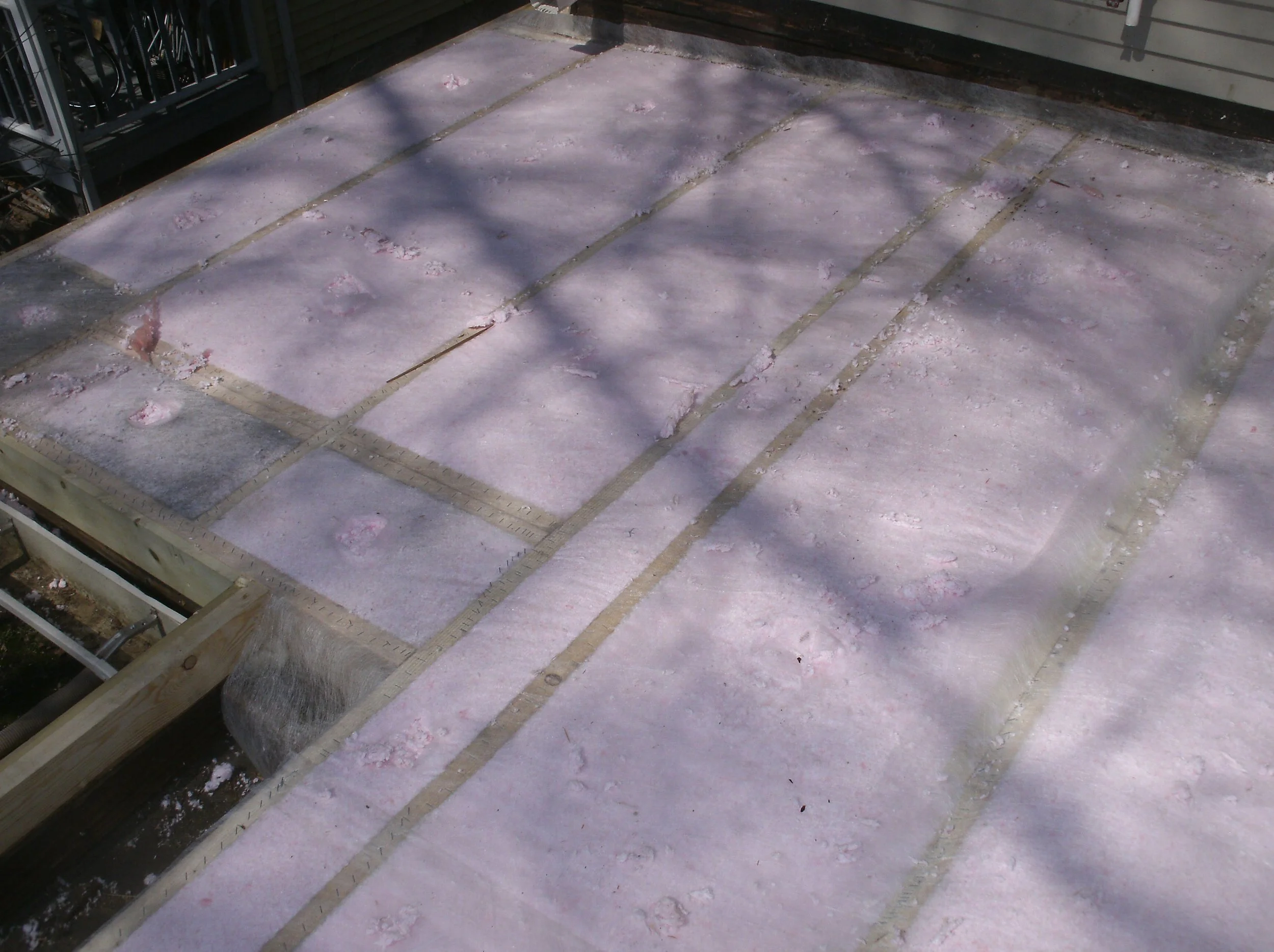 You can see the BIBS blown in insulation between all the joists