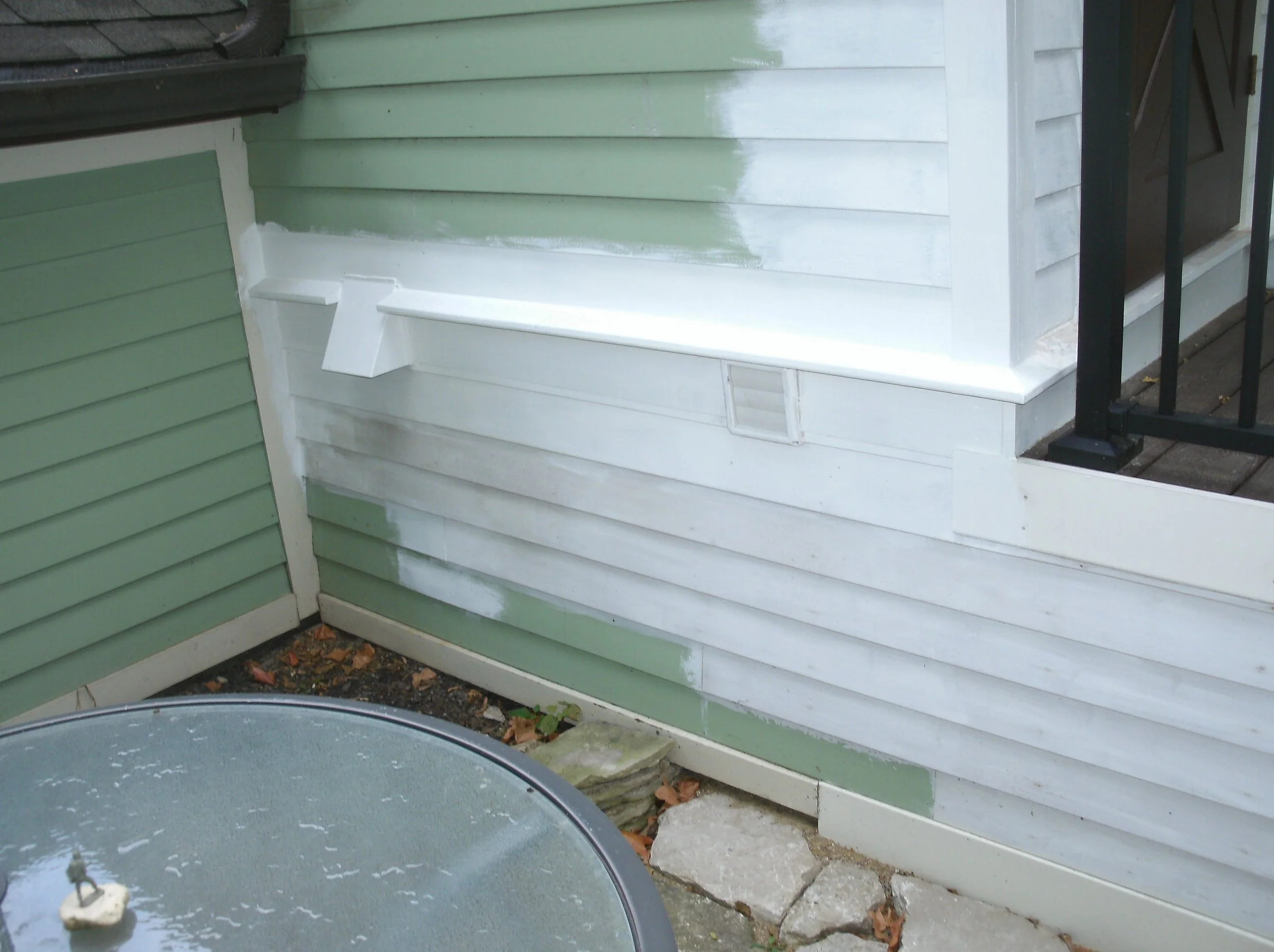 Rotted wood replaced under door, facia, siding, vertical corner trim. All primed.