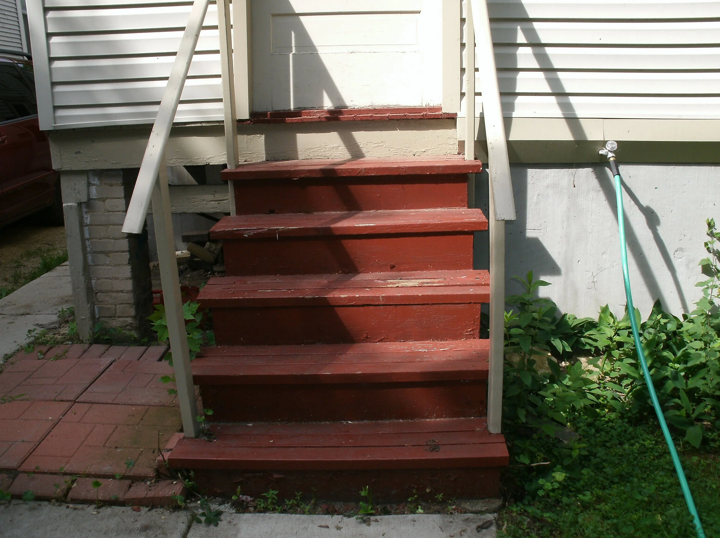 Funky, damaged back stairs. Note: minimal rails way out of code.
