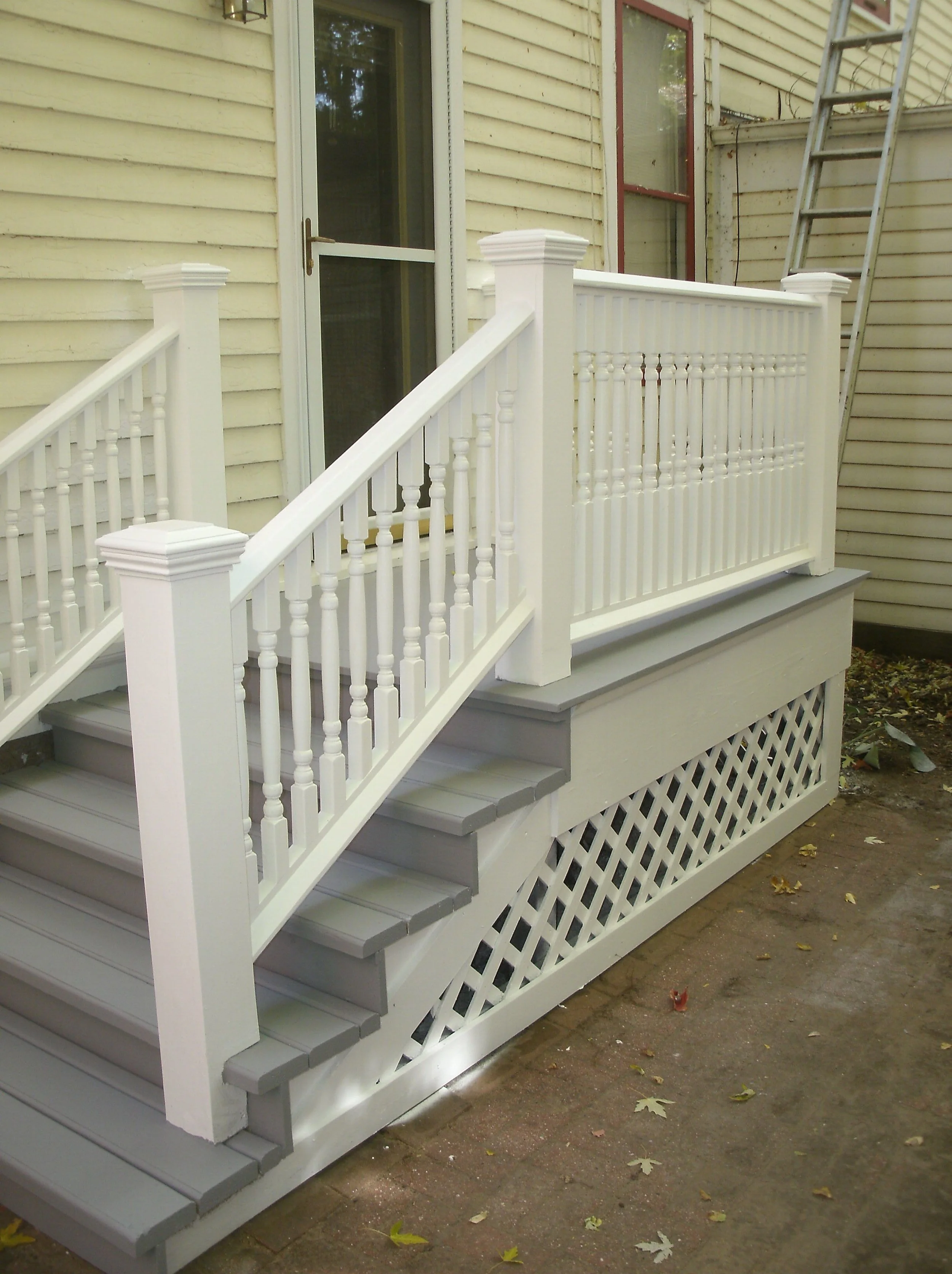 Full front view of the stairs, landing, rails and rebuilt drip edge-siding bottom