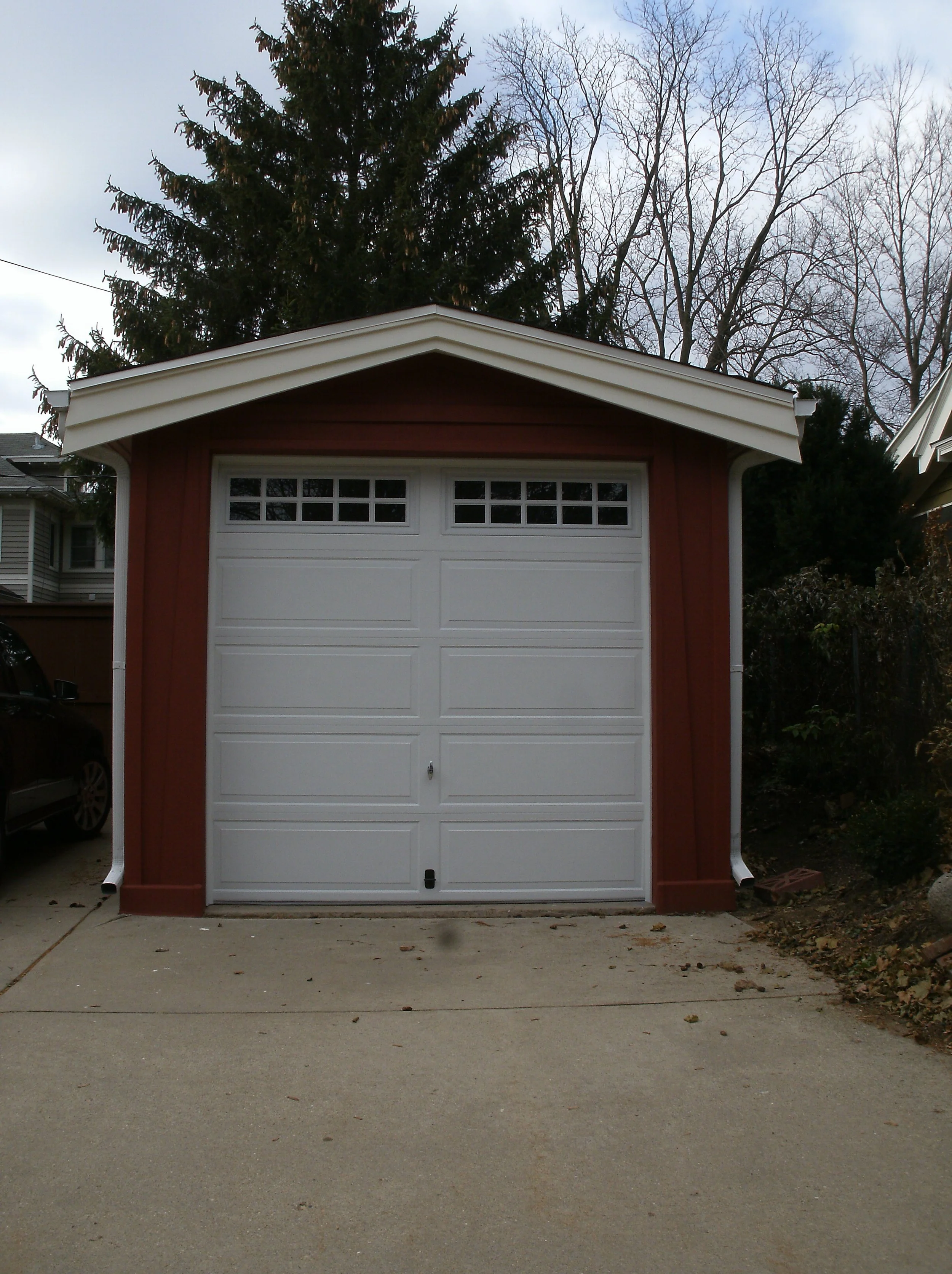The finished garage with all trim, installed and painted and new door