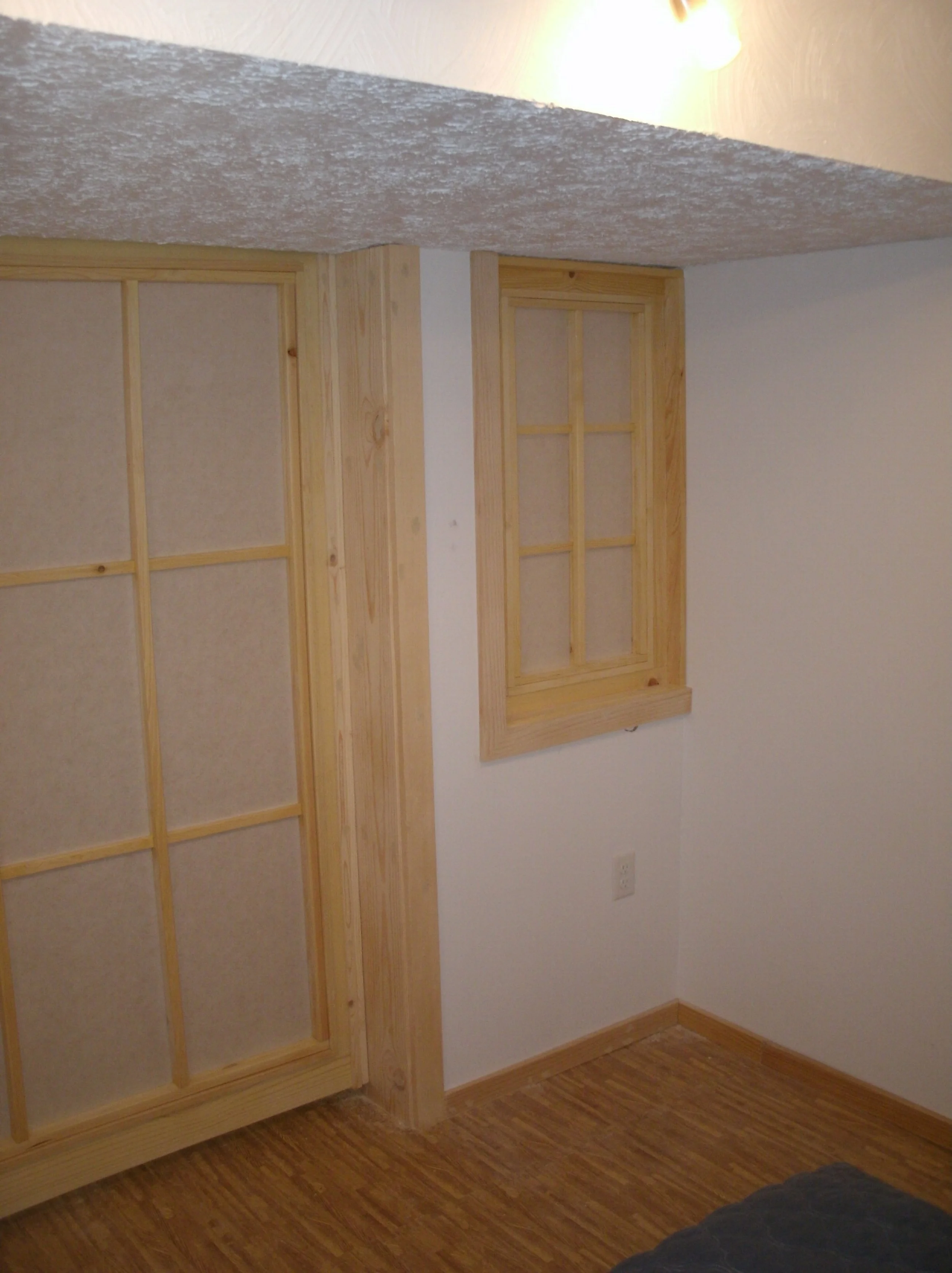 View from inside the room with doors and window trimmed in place	
