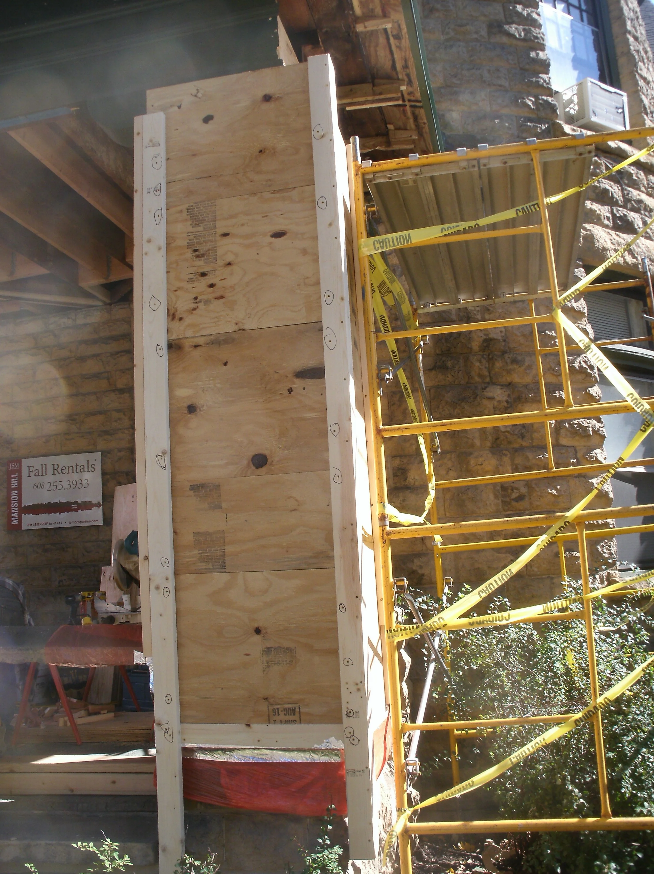 Stone pier clad in plywood, and 2x4 corners to protect the piers.