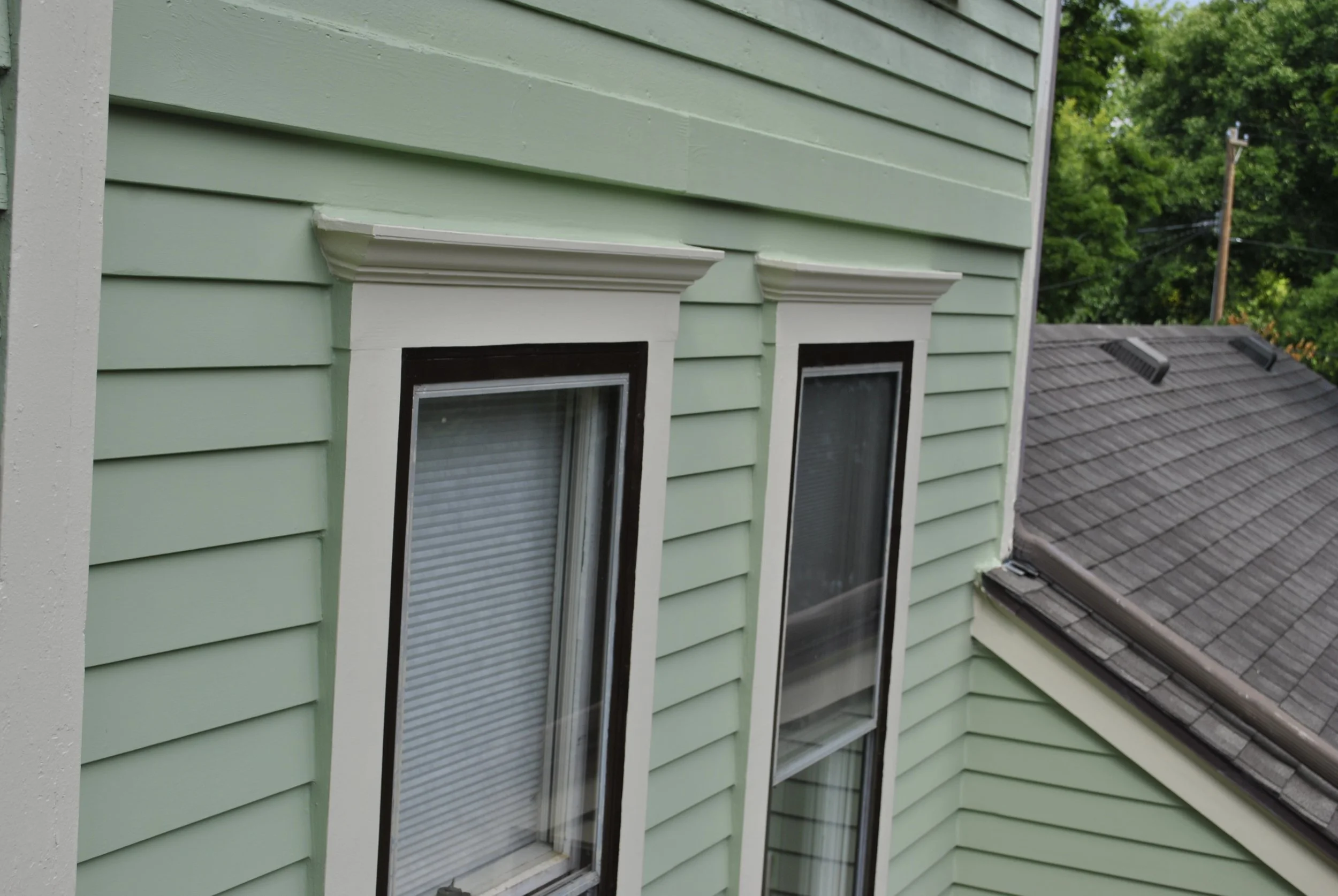 View of the crown molding and metal caps on these two windows.