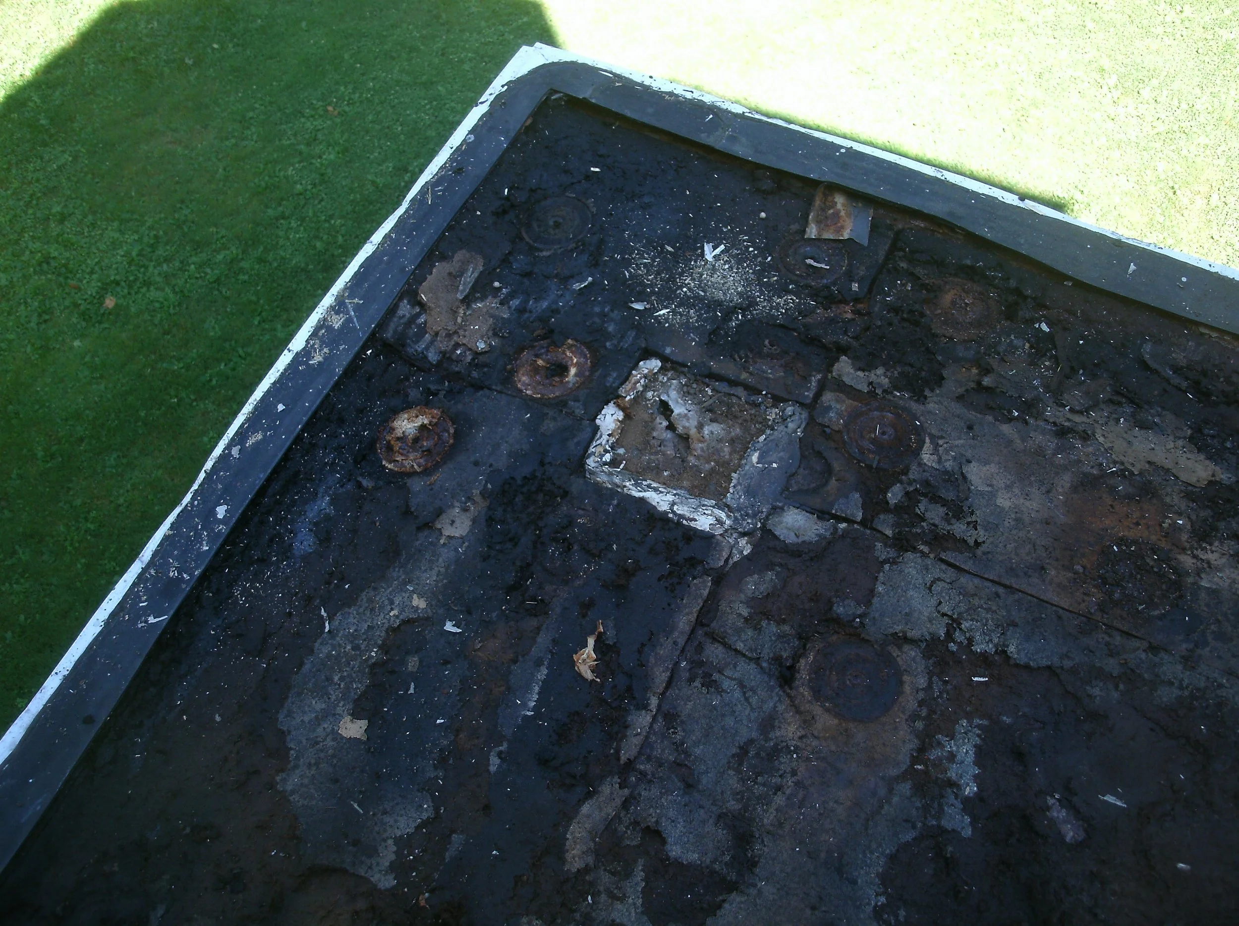 Old, cracked, funky 35 year-old rubber roof over 120 year-old rusty metal roof