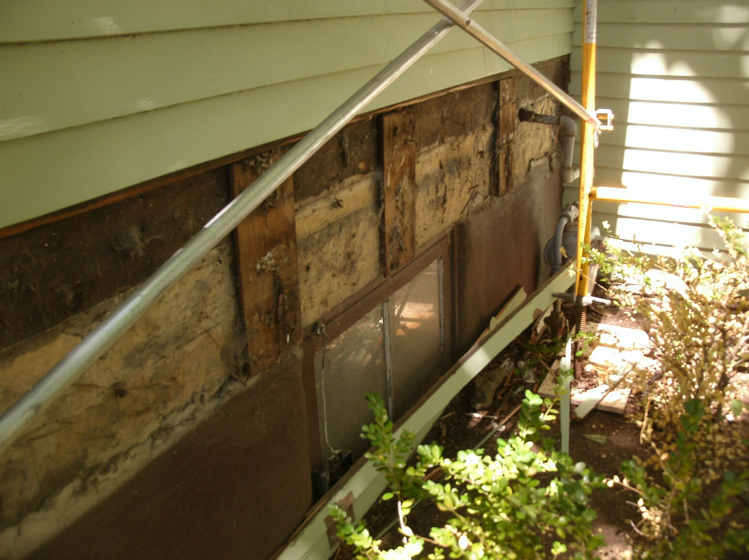 Sheathing restored, new generously sized drip edge begun, new trim below
