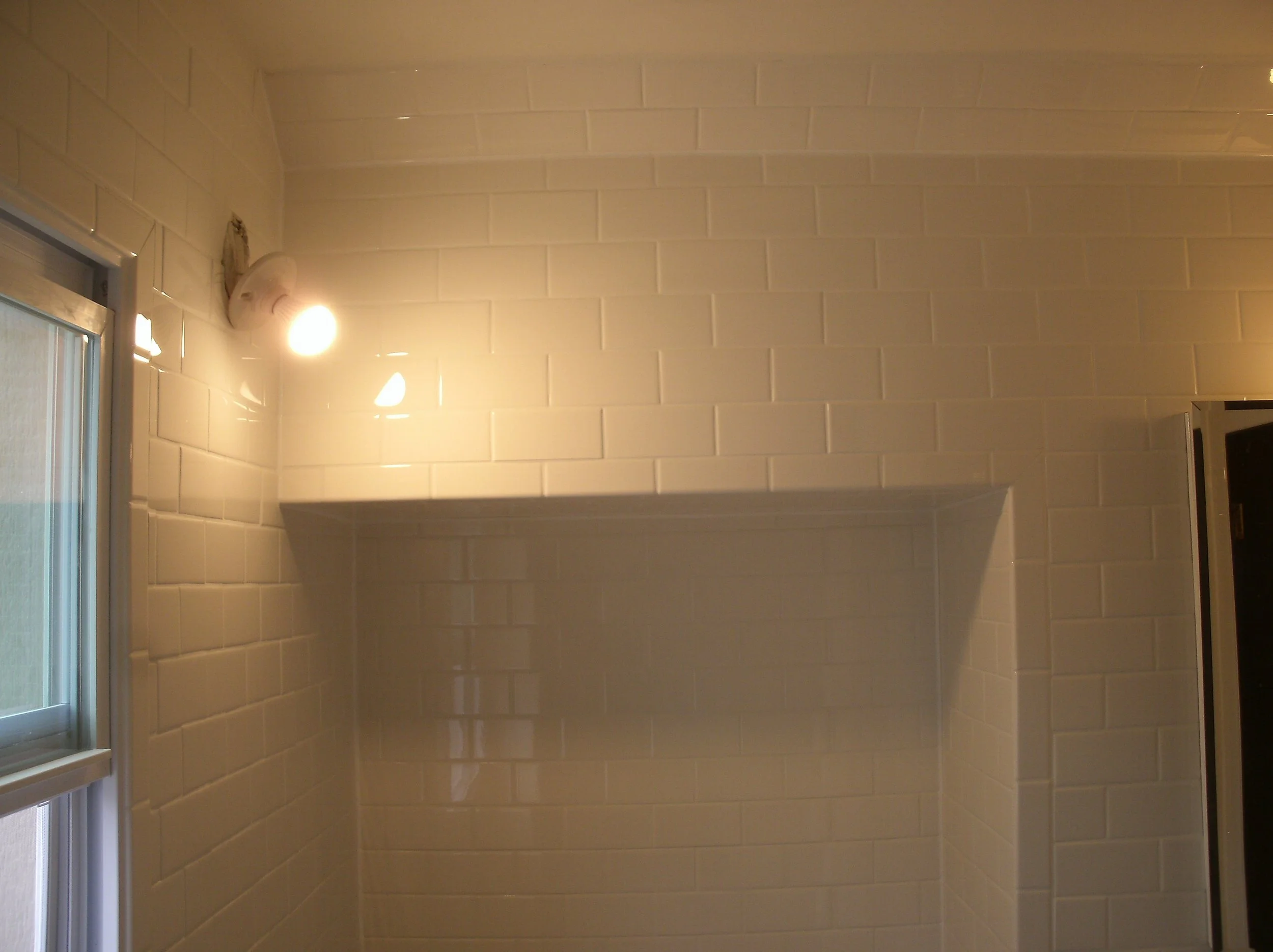Tiled toilet alcove, tiles walls, strip of tiled roof line