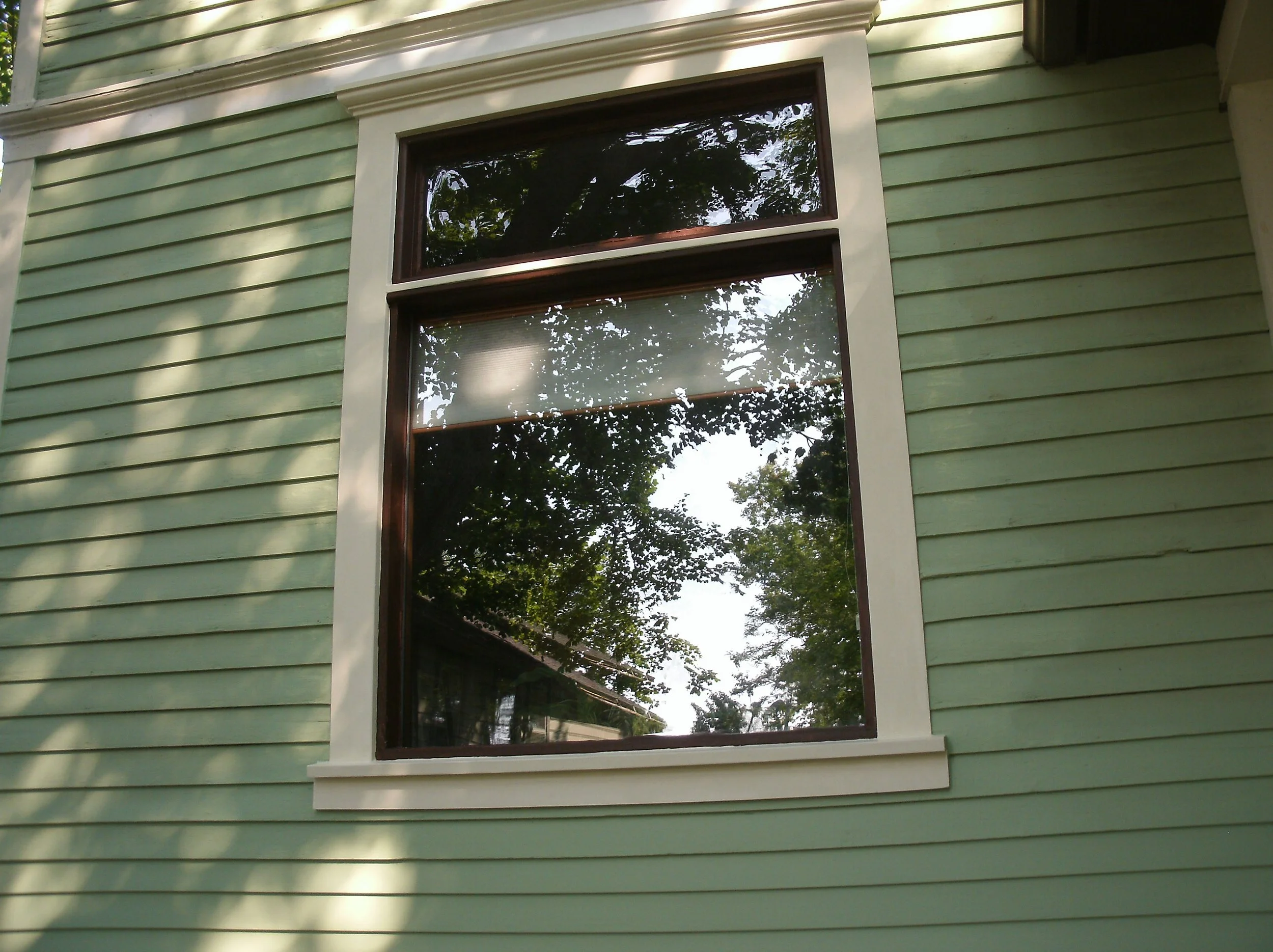 Detail of finished drip edge and window trim, primed and painted.