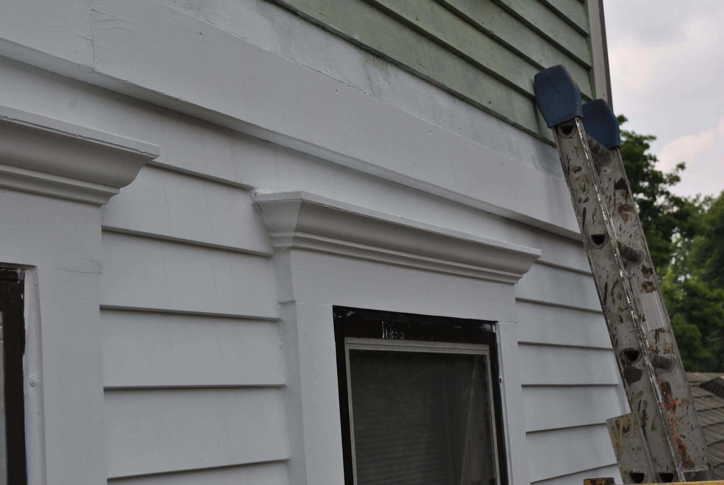 Another view of the new casing, crown molding, metal cap and siding.