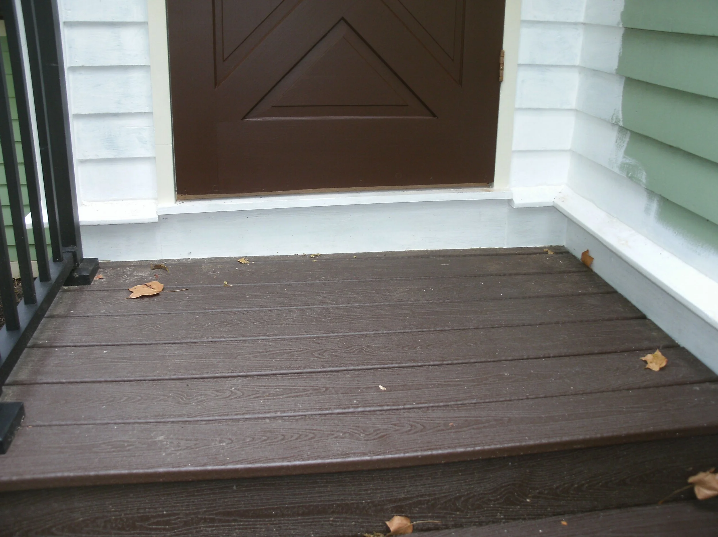 Close up of the replacement wood beneath and on both sides of the storm door.
