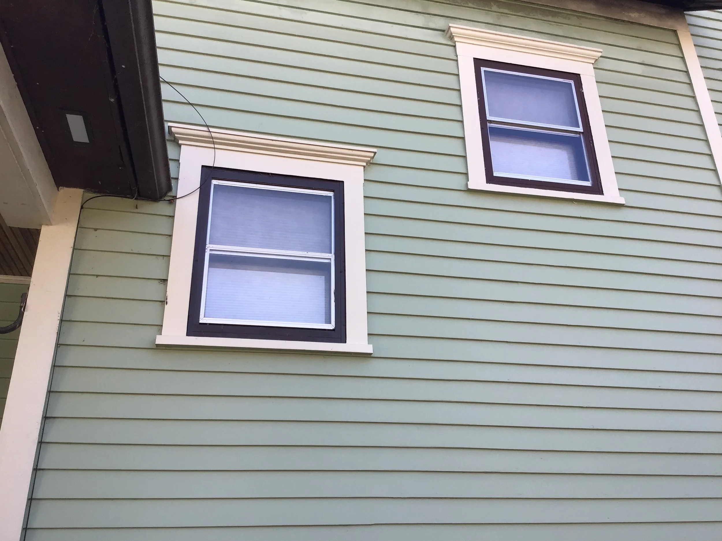 Nice view of two windows and much new siding.