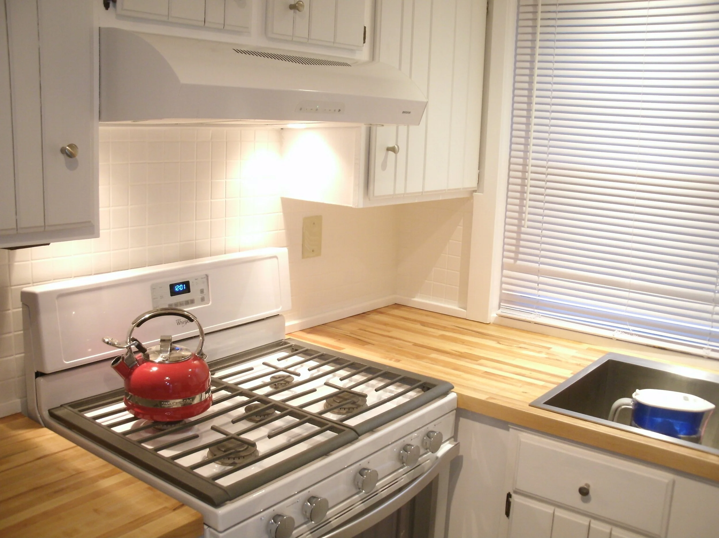 A View of new countertops, white tile splash, and special trim as necessary